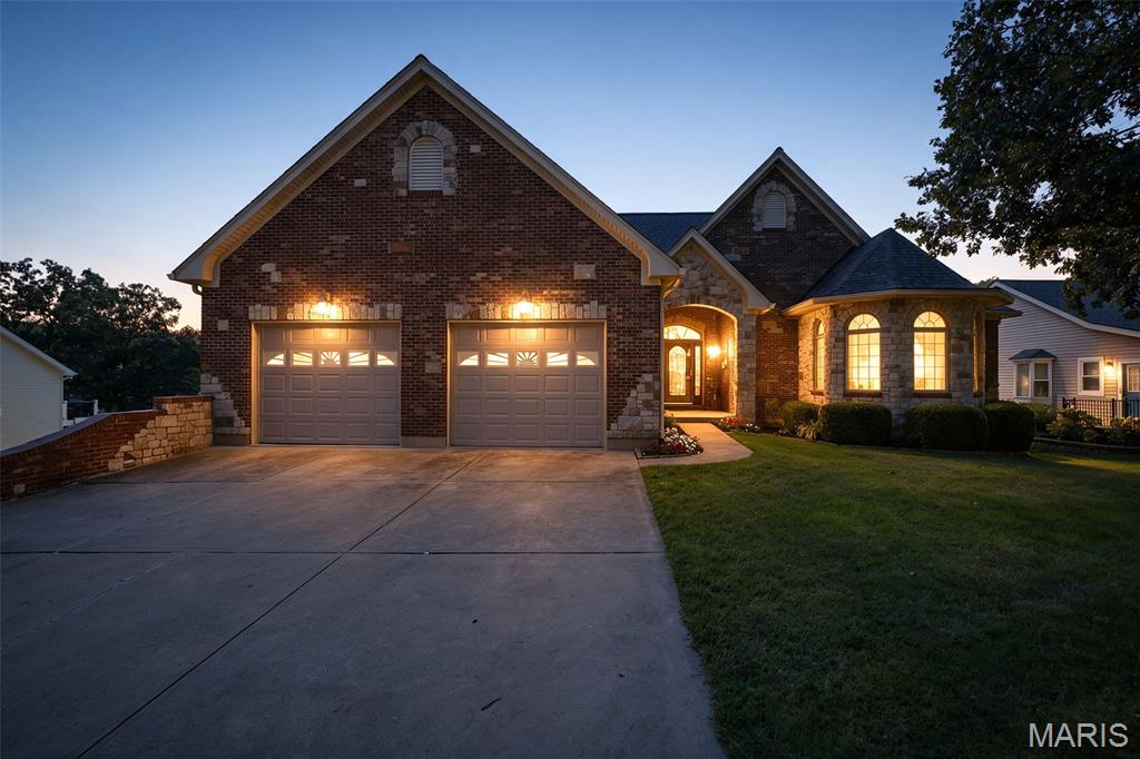 Welcome to lakefront living at its finest in sought-after Raintree Plantation! Offered for sale for the very first time by its original owner, this stunning 4-bedroom, 3.5-bath home has been lovingly maintained and is ready for its next chapter. Perfectly positioned on the water, you'll enjoy breathtaking views, your own covered boat dock, and endless opportunities for lakeside relaxation and recreation. Step inside to find beautiful hardwood flooring, granite countertops, an electric cooktop, and a double wall oven designed for both everyday living and entertaining. The spacious primary suite is a true retreat, featuring a large en suite bath complete with a walk-in shower, relaxing jetted tub, and ample space to unwind after a day on the lake. A generous main-level laundry room adds everyday convenience, while the open and inviting floor plan creates the perfect backdrop for gathering with family and friends. The finished lower level is an entertainer's dream, featuring a large recreation area, custom bar, and plenty of room for game nights, celebrations, or simply unwinding after a day on the lake.  Home has Pella windows throughout.  Outside, the expansive deck invites you to sip your morning coffee, host summer gatherings, or enjoy peaceful evenings overlooking the water.  Lake front there is a large patio, covered boat dock and storage making the "Lake Life" a great experience.  A tucked-under 2-car garage with workshop space provides room for hobbies, storage, and all your lake toys. Located in one of Jefferson County's most desirable communities, Raintree Plantation offers an unmatched lifestyle with a golf course, swimming pool, pickleball courts, clubhouse, and four beautiful lakes.  This exceptional waterfront retreat combines comfort, elegance, and recreation in one unforgettable package. Rarely does a one-owner home of this caliber become available. This is truly a must-see property that captures everything buyers love about Raintree living.