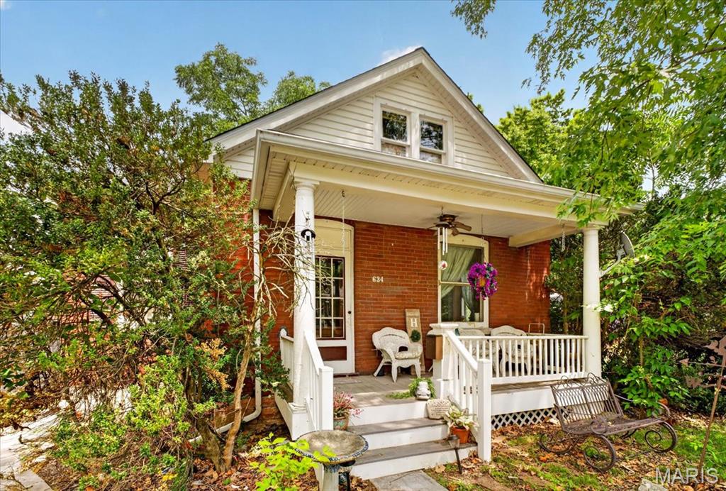 This Charming 1.5 story all brick home located in the heart of Columbia, 1 block off of main street and around the corner of the walking trails is just waiting for you to call HOME.  You will fall in love with the Cozy & Inviting front porch that is perfect for your morning coffee. Make your way inside to the foyer where you will notice the tall ceilings, real hardwood floors, beautiful wood doors and trim throughout the entire main level.  First you will find the Primary suite—perfect for easy living. Next, Make your way to the Large living room with large windows allowing the natural light to fill the room and plenty of space to entertain your guests. Conveniently located off the living room is the updated full bath featuring a large walk-in shower! Around the corner is the kitchen/dining area with oak cabinets, huge walk-in pantry and Unique Farmhouse sink. The possibilities are endless in the Upper level where you will find the Huge Second bedroom (big enough to make into 2 bedrooms) and rough-in for the Second full bath.  Step outside, thru the sun porch to enjoy the fenced-in backyard with mature trees making it ideal for pets or play!  Perfectly located within Walking distance to the Historic Downtown Restaurants & Businesses, featuring classic touches and practical updates throughout, this home is full of charm and ready for you to Live Where You Love!