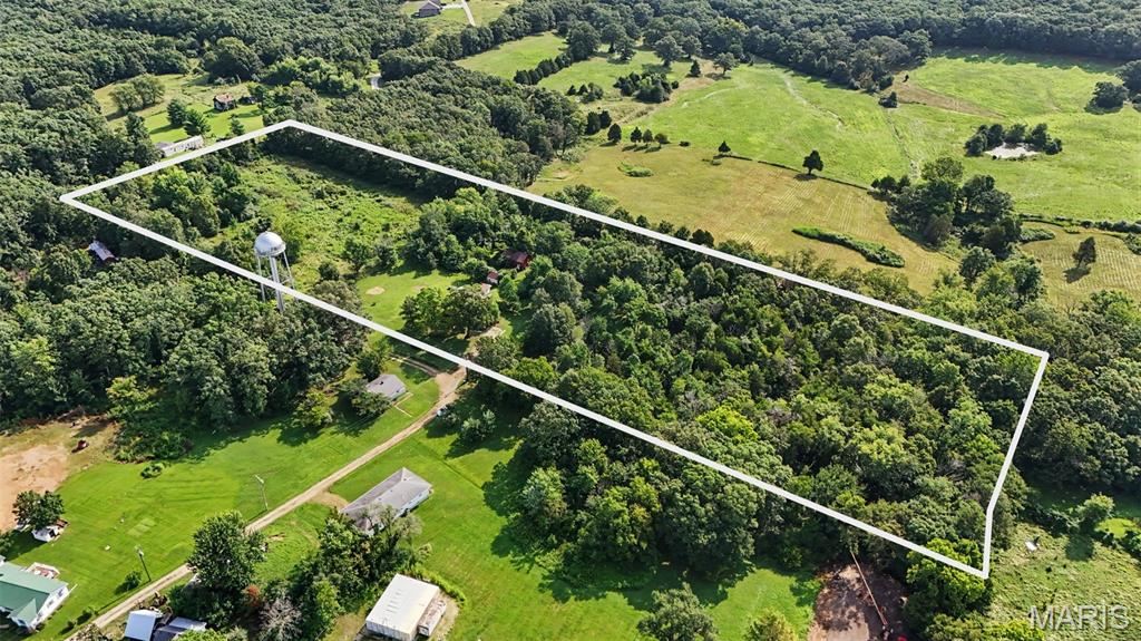 9 Acres of Country Freedom Await! Escape to the countryside and discover the opportunity to create the hobby farm or rural retreat you've always wanted. With approximately 9 acres, multiple outbuildings, a chicken coop, city water, and a lagoon system already in place, this property offers the space and infrastructure to bring your vision to life. Whether you're dreaming of raising animals, planting a large garden, building a workshop, or constructing your forever home, the possibilities here are endless. The existing farmhouse offers a starting point for those willing to renovate, featuring a metal roof, vinyl siding, and updated electrical service. The home includes a kitchen, living room, full bath, laundry area, a versatile main-level room that could serve as a bedroom or office, plus three additional bedrooms and a half bath upstairs. The home will require substantial updates and is being offered as an opportunity for renovation or replacement. Rarely do properties with this much acreage and potential become available. Bring your imagination and make this slice of the countryside your own!