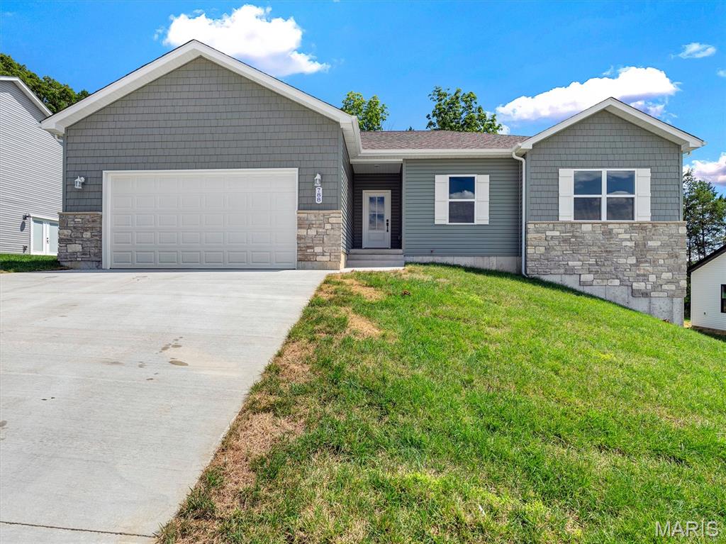 Park Place proudly presents a quality-crafted new construction ranch home by ELS Homes, a trusted local builder. This thoughtfully designed 3 bedroom, 2 bathroom home (Ellington Plan) sits on a desirable lot and offers both style and functionality throughout.
The kitchen features white cabinetry with crown molding, granite countertops, and a center island with bar seating, all flowing seamlessly into the open concept dining and living areas. Nine foot ceilings enhance the spacious feel, while the laundry room is conveniently located at the garage entry.
Off the dining area, a single exterior door with full glass and integrated blinds leads to a 10x10 patio, perfect for outdoor enjoyment. The great room is highlighted by luxury vinyl plank flooring in gray tones, and an elegant stair rail system leading to the lower level.
The primary suite offers a comfortable retreat with a large walk in closet and a spacious bathroom featuring a white marble topped vanity and a private shower with glass door. The second and third bedrooms are nicely sized and located near the hall bathroom with a tub and shower combination.

The walk out basement includes nine foot ceilings, a bathroom rough in, side walk out, and excellent potential for future finishing.

Notable upgrades include nine foot ceilings throughout, white windows, white gutters, soffit & fascia, an upgraded lighting package, trim package, black hardware and fixtures, a partial stone front exterior, a craftsman style front entry door, and an oversized two car garage that is insulated and drywalled.

Quality construction, thoughtful upgrades, and local craftsmanship come together beautifully in this Park Place home.  DON’T MISS THIS ONE.