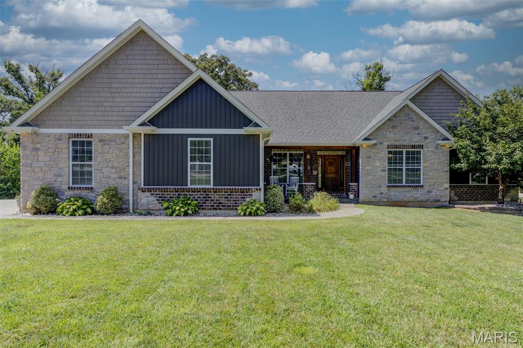 Welcome to this stunning custom-built ranch nestled in the heart of New Melle! Offering over 4,000 square feet of beautifully finished living space, this exceptional home features 4 bedrooms, 3 full baths, and 1 half bath, thoughtfully designed for both everyday living and entertaining.

Step inside to soaring 10-foot ceilings, abundant natural light, and an open-concept floor plan that creates a warm and inviting atmosphere. The gourmet kitchen is the heart of the home, showcasing a large center island, ample cabinetry, and seamless flow into the dining and living areas. A spacious mudroom adds convenience, while exceptional storage can be found throughout the home.  

The luxurious primary suite offers a spa-like bath and an oversized walk-in closet. Each additional bedroom also features its own walk-in closet, providing plenty of storage for family and guests.

The finished walk-out lower level adds over 2,000 square feet of living space and is an entertainer's dream. Enjoy a full custom bar, built-in surround sound speakers, a private guest suite, a cozy sleeping nook, and a concrete-encased safe room for added peace of mind.

Outside, you'll love the private, tree-lined backyard designed for relaxing and gathering. The covered deck overlooks an impressive 1,300-square-foot stamped-concrete patio complete with a built-in fire pit—perfect for entertaining year-round.

Car enthusiasts and hobbyists will appreciate the oversized 32' x 30' side-entry garage with 9-foot doors, offering plenty of room for vehicles, tools, and toys.

Located in the highly sought-after Francis Howell School District, with Daniel Boone Elementary, Francis Howell Middle, and Francis Howell High School, this exceptional home combines quality craftsmanship, thoughtful design, and an unbeatable location. This is one you won't want to miss!