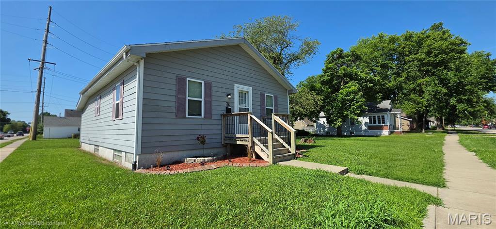 Charming Updated Ranch on Large Corner Lot!

From the moment you arrive, this charming and well-maintained ranch home welcomes you with an inviting curb appeal that makes you want to pause and stay awhile. The attractive gray siding is accented by contrasting shutters and crisp white trim, creating a clean, modern look. Before you even step inside, the wooden front porch decking and railing provides the perfect spot to relax with your morning coffee. Thoughtfully landscaped flower beds with decorative edging and fresh mulch frame the home. The spacious, level corner lot offers plenty of room for outdoor enjoyment, beautifully enhanced by wide frontage, mature trees, and an established neighborhood setting.

Step inside to a bright living room featuring durable, modern, multi-toned luxury vinyl plank flooring that flows seamlessly throughout the main level. The neutral contemporary paint palette is perfectly accented by crisp white chair rail molding and matching baseboards. A wide cased opening provides a free-flowing feel, effortlessly connecting your main living space to the heart of the home for easy entertaining.

The spacious kitchen blends modern updates with rustic character, highlighted by a unique red brick accent wall. Bright white cabinets with sleek black hardware provide abundant storage and are complemented by updated stainless steel appliances, including a refrigerator and electric range. With plenty of counter space framing a double-bowl sink, this kitchen is as highly functional as it is inviting.

This turn-key home features 3 bedrooms, 1 full bath, and a full unfinished basement offering excellent storage or potential future equity. Best of all, you are in close proximity to vibrant downtown O'Fallon festivities, local restaurants, and shopping. Don't miss this beautiful gem—it is ready for its next chapter to begin!