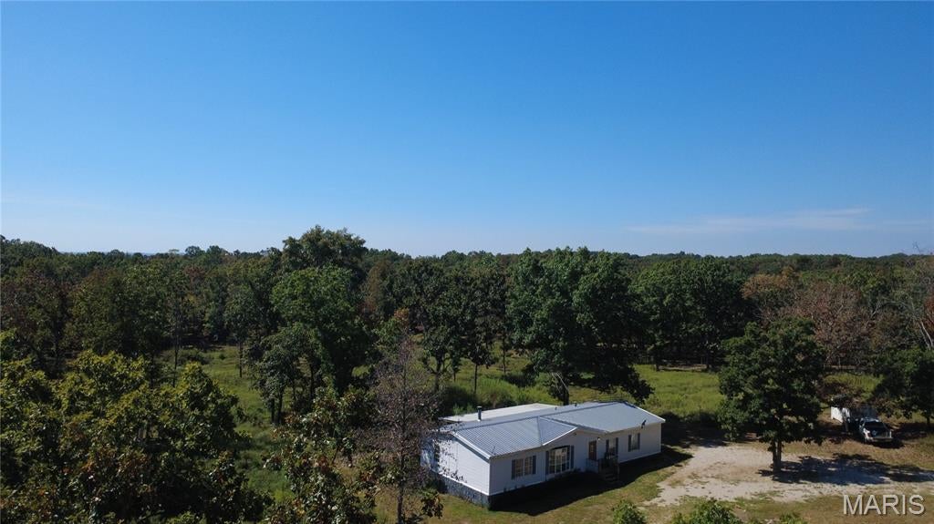 COUNTRY LIVING WITH ROOM TO ROAM! Enjoy the privacy and freedom of 5 acres with this spacious 1,792 sq. ft. manufactured home featuring 3 bedrooms and 2 baths. With NO HOA and NO restrictions, this property offers the flexibility to create the lifestyle you’ve been looking for—whether that means homesteading, gardening, raising livestock, enjoying the outdoors, or simply escaping the pace of city life.
The home features a wood-burning fireplace, perfect for cozy evenings, along with a large 12' x 32' covered back deck/porch providing plenty of space to relax, entertain, or enjoy peaceful country evenings. The property also includes a new fence suitable for horses or livestock and a new well. The seller is offering a home warranty plan and flooring allowance, providing added peace of mind and an opportunity to personalize the home.
Enjoy the slower pace and privacy of country living while remaining conveniently accessible to medical care, doctors, shopping, and other everyday amenities. Outdoor enthusiasts will appreciate the area's access to Missouri rivers, creeks, hunting opportunities, conservation lands, and numerous state parks.
Whether you're looking for a homestead, mini-farm, horse or livestock property, hunting retreat, or simply a place with room to breathe, this 5-acre property offers space, privacy, freedom, and the opportunity to enjoy a simpler way of life.