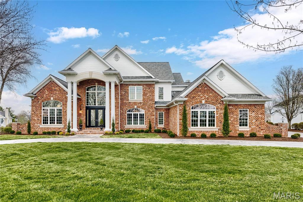 Spectacular 7195 sq ft Georgian Colonial in prestigious Camelot. This custom-built home features superior craftsmanship & distinctive design elements throughout including oak hardwoods, 10’ ceilings, detailed trim work & palladian windows. Impressive covered porch entrance highlighted by architectural columns leads to 2-sty marble foyer with dramatic curved staircase, private study with built-in bookcases & French doors, formal dining room framed by arched entryways and stunning great room with cast stone fireplace, wet bar & 2-sty windows that overlook pool & parklike backyard. The main living area unfolds into the designer kitchen featuring 42” glazed white cabinetry, granite countertops, KitchenAid appliances, butterfly center island, butler’s pantry & convenient planning center. Light-filled breakfast room & vaulted hearth room with floor-to-ceiling stone fireplace provide a welcoming gathering place. Coffered primary bedroom suite offers an appealing retreat with customized walk-in closets, wide bay window & beautifully appointed marble bath. Front & rear staircases access 3 additional bedrooms, 1 with ensuite bath & 2 with Jack n’ Jill bath. Lower Level entertainment space includes recreation room, family room with brick fireplace, game room, media room & gathering bar plus 5th bedroom & pool bath. Atrium doors open to outdoor living area with deck, covered patio, pool & hot tub surrounded by landscaped gardens.