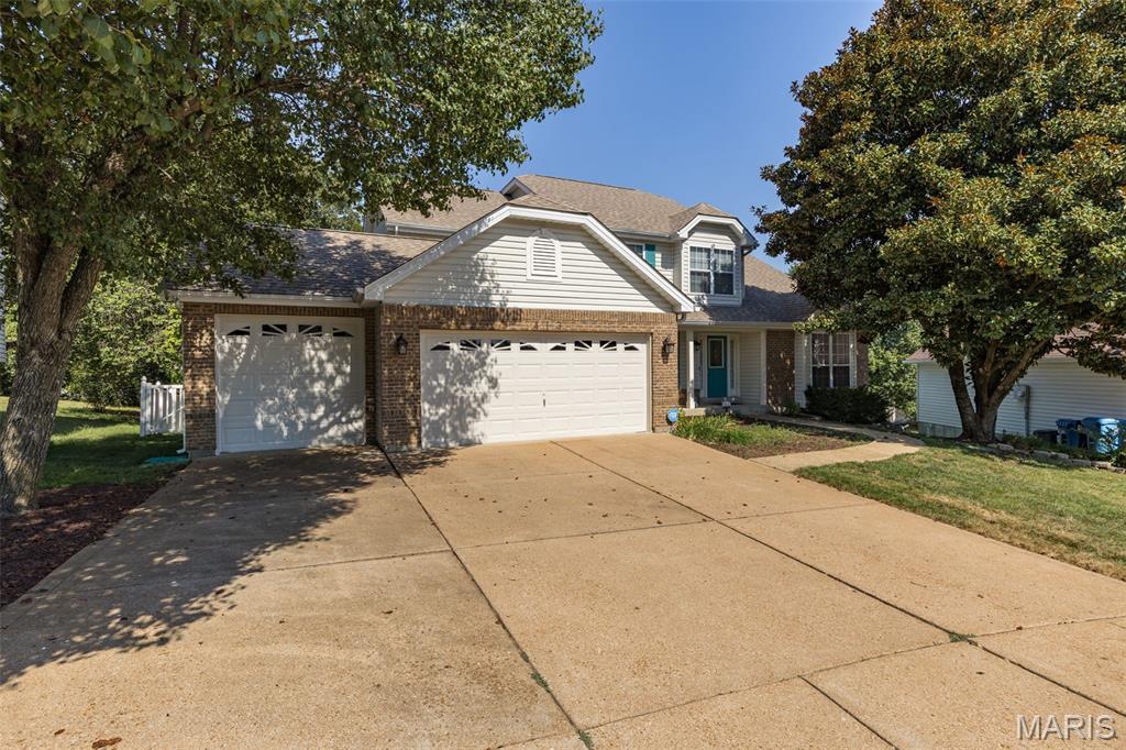 Beautifully maintained 1.5-story home located in the highly desirable Rockwood School District and just minutes from Gravois Bluffs shopping, dining, and entertainment.  First time offered on the market kept meticulously: never smoked in, no pets or shoes on the carpet.  The inviting foyer features an open staircase, abundant closet space, 1/2 bath, opens to the formal living room with vaulted ceiling and separate formal dining room. The stunning two-story great room showcases floor-to-ceiling windows, a gas fireplace, and breathtaking views of the private wooded backyard.  
     The spacious kitchen offers custom cabinetry, center island with seating, a large breakfast room with access to the expansive deck overlooking the fenced backyard.  The main-floor primary suite features vaulted ceilings, a large luxury ensuite with vaulted ceiling, walk-in closet, dual vanities, soaking tub, and oversized separate shower. Main-floor laundry and an oversized 3-car garage add convenience. 
     Upstairs, you'll find an open loft, three generously sized bedrooms with ample closet space, and a full bath with separate tub and shower. The partially finished walkout lower level offers exceptional versatility with a gas fireplace, recreation room, dining area, full bath, additional living space, storage, and utility rooms, making it ideal for entertaining, guests, or potential in-law quarters. 
     Enjoy your own private backyard oasis featuring a large deck, spacious patio, mature landscaping, charming sitting areas, walkways, fenced yard, oversized lot, and an in-ground sprinkler system. Move-in ready and includes a home warranty. A rare opportunity to own a spacious home with exceptional indoor and outdoor living spaces in a prime location.
