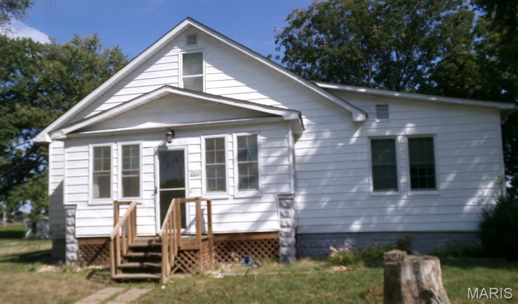 This house is situated in rural St. Clair county. There are 4 lots that equal around a half an acre. This is a 1.5 story 3 bedroom 1 bath home with a living room, a den a large laundry room, an upper loft/playroom and a basement. There is an attached storage building and an attached 2 car garage. There is also a detached storage shed.. The County records show that the home was updated in 1995..