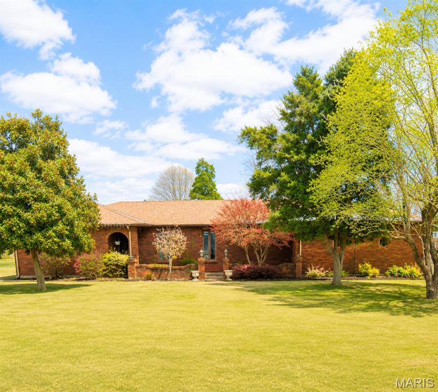 Welcome to this beautifully maintained all brick ranch offering the perfect blend of comfort, space and functionality. Featuring 3 bedrooms and 2.5 bathrooms, this home boasts a spacious floor plan with plenty of extra living space to fit your lifestyle. The inviting, large living area is highlighted by built in shelves and a cozy gas fireplace, creating the perfect gathering spot for family and friends. Updated lighting and appliances add style throughout the home. Enjoy year round relaxation in the attached screened-in porch, ideal for morning coffee or unwinding after a long day. The two car garage provides ample storage, while the large, flat backyard offers endless possibilities. With its timeless brick exterior, thoughtful updates and generous living spaces, this ranch style home is ready for its next owner to move right in and enjoy.