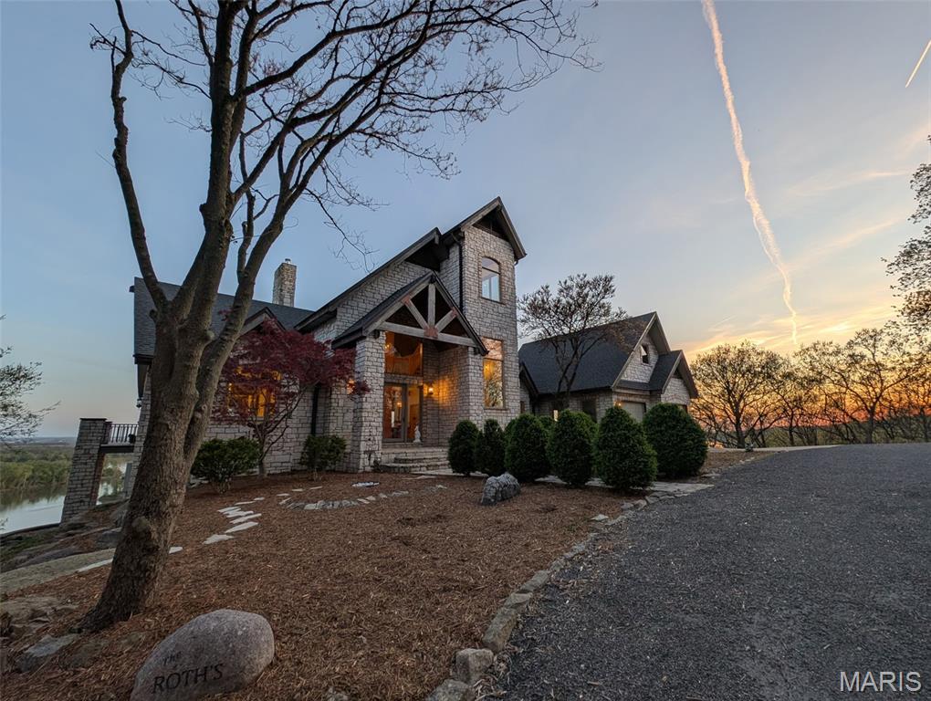 After a day of historic downtown entertainment, go up where the bluffs meet the sky and relax on the massive Palapi Brazillian Hardwood deck and drink a glass of wine and enjoy the spectacular view of the Illinois/Mississippi river confluence until you get the best sunset in all of Jersey county. Retire to your slumber in this 3 bedroom, 2 full, 2 half bath full stone masonry castle where eagles fly. Wake up and do it all again! Amazing views from every room. Massive 31’ vaulted great room ceiling w/woodburning fireplace, open layout to dining & kitchen area. New granite countertops, all appliances stay. Plus coffee bar area. Main floor laundry mudroom off the oversized garage. Main floor primary suite with amazing view. Walkin closet w/organizer. Double bowl vanity w/separate soaking tub & tiled shower. Brand new marble tile flooring as well. Upstairs is an unbelievable loft office to work from home while you also enjoy the views. Climb the stairs again to the tower and drink your coffee and read a book at the rooftop view of the rivers. Venture downstairs and find the family room – pool room – and bar are for entertaining all with full glass views. Enclosed screen room. 2 more bedrooms with you guessed it – VIEWS! 2 geothermal units replaced in ’21. Norweco aeration pumped & serviced ’24, new gate ’24, and new roof ’25, primary bathroom total remodel ‘26. All of this on 5.01 acres. All showings to provide preapproval/proof of funds and be accompanied by listing agent.