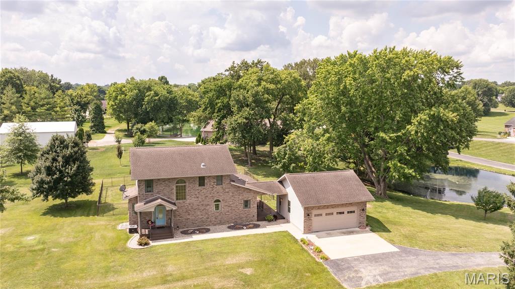 Welcome home to this immaculately maintained 2-story home situated on 2 beautiful acres, offering space, comfort, and a peaceful setting. The updated kitchen comes complete with appliances and opens to the dining room, while the living and dining rooms feature beautiful hardwood floors. Just off the main living area, the sunroom is the perfect place to relax and enjoy views of the backyard year-round. The main level also offers the convenience of a full bathroom and main-floor laundry. Upstairs you'll find three spacious bedrooms, including a large primary bedroom with a huge walk in closet, along with a second full bathroom. The full unfinished basement features an egress window, rough in for a 3rd bathroom, providing endless possibilities for future living space while offering plenty of storage. Step outside to enjoy the fenced backyard with brick patio, a peaceful pond, and plenty of room to spread out and entertain. This well-cared-for home is move-in ready and offers the perfect blend of comfort, space, and country living. Agent related to seller.