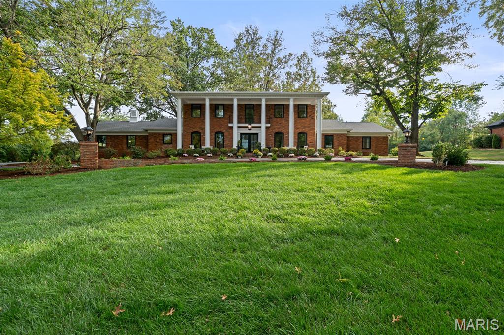 436 Tregaron Place is an exquisitely designed and beautifully updated 1.5-story residence offering over 6,600 sq ft of finished living space on a stunning 0.96-acre wooded lot in the heart of Frontenac. Blending timeless architecture with modern updates, this 4-bedroom home is nestled within the award-winning Ladue School District.
The stunning interior features a gorgeous marble foyer, extensive millwork, and refinished hardwood floors. The expansive family room boasts a striking white brick fireplace, custom built-ins, and oversized windows that flood the space with natural light.
The chef's kitchen is a showstopper — beautifully renovated with marble countertops, professional-grade Wolf range, Sub-Zero refrigerator, statement herringbone tile backsplash, pendant lighting, and a spacious island perfect for entertaining.
The main-floor primary suite is a private retreat, complete with a sitting room, two walk-in custom closets, and a luxurious marble bath with heated floors. Additional main-level highlights include a formal dining room, laundry room, and a 3-car side-entry garage.
Upstairs, you’ll find three large bedrooms and two full baths, while the finished lower level features a wide-open recreation space, playroom, half bath, and plenty of storage.