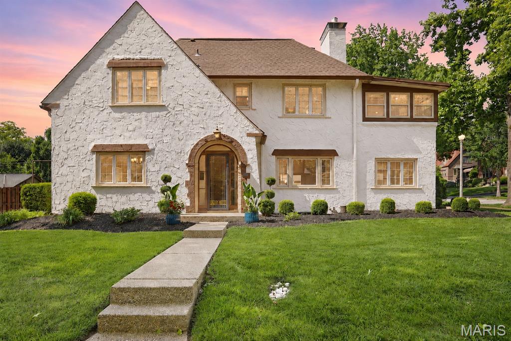 Welcome to this timeless Clayton residence, where classic architecture, generous living spaces, and an exceptional location come together in one of the area’s most sought-after neighborhoods. Rich in character and filled with natural light, this home showcases beautiful hardwood floors, elegant archways, and thoughtfully preserved architectural details throughout.

The spacious living room features a gas fireplace and serves as the heart of the home. French doors open directly to the beautifully designed two-tiered floating deck, creating a seamless connection between indoor and outdoor living. Whether hosting guests, enjoying a quiet morning coffee, or unwinding at sunset, this inviting space offers an exceptional setting for year-round enjoyment. Just off the living room is a versatile adjoining space ideal for a home office, library, sitting room, or creative retreat.

A formal dining room provides an inviting setting for everyday living and entertaining, while the well-appointed kitchen offers granite countertops, stainless steel appliances, double ovens, abundant cabinetry, and a charming banquette seating area.

Upstairs, the primary suite features double closets and an adjoining flex space that can serve as a dressing room, office, fitness area, or private retreat. Two additional bedrooms and beautifully updated baths provide comfort and flexibility. The third level offers a large loft space with an additional half bath, creating endless possibilities for a media room, guest suite, studio, recreation area, or work-from-home environment.

The walk-up basement provides exceptional storage and future expansion potential. Outside, the two-tiered floating deck and patio overlook the level backyard, creating an ideal setting for outdoor entertaining, dining, gardening, or simply relaxing outdoors. As the day winds down, enjoy spectacular sunset views from the deck, offering a peaceful backdrop for evening gatherings or quiet moments at home. The level lot and expansive outdoor living areas provide a rare combination of usability, comfort, and enjoyment. A detached two-car garage offers additional convenience and storage.

Situated on a desirable lot in the heart of Clayton, across from Glenridge Elementary and just moments from Wydown Boulevard, Shaw Park, Downtown Clayton, restaurants, coffee shops, shopping, Washington University, Forest Park, and major highways, this location offers the ideal balance of neighborhood charm and urban convenience.

Combining timeless character, flexible living spaces, exceptional outdoor living, and an outstanding location, this is a rare opportunity to own a distinctive Clayton home with room to live, work, entertain, and grow.
