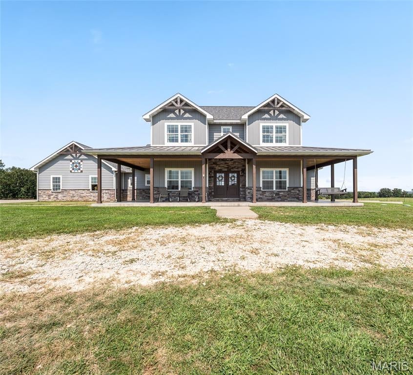 STUNNING ESTATE PROPERTY ON APPROXIMATELY 79 ACRES! Just minutes from the vast amenities Rolla offers, this exceptional property boasts the perfect blend of luxury, privacy, income potential, and breathtaking Missouri hilltop views. The estate includes a luxurious 5-bedroom, 5-bathroom main home, the original farmhouse currently used as a rental, fenced pastures, multiple ponds, a creek, barn, and several outbuildings. The impressive main residence welcomes you through grand double doors into a spacious interior featuring luxury vinyl plank flooring, soaring cathedral ceilings, and an inviting gas fireplace accented with stone and shiplap. The open-concept design creates an effortless flow between the spacious living area, dining area, and stunning eat-in kitchen. The kitchen is highlighted by elegant quartz countertops, stainless steel appliances, a pot filler above the range, and a cleverly designed hidden walk-in pantry. A balcony overlooking the living area adds an impressive architectural touch. The spacious primary suite offers a walk-in closet and private bath featuring dual vanities and a beautifully tiled shower. Additional highlights include four more bedrooms, four additional bathrooms, a dedicated office, and an unfinished basement offering excellent potential for future expansion. Adding exceptional versatility and income potential, the charming original farmhouse is currently utilized as a rental and offers 4 bedrooms and 1 bathroom, along with its own private well and septic system. Outside, the possibilities are endless with approximately 79 acres of fenced pasture, multiple ponds, a creek, barn, outbuildings, and picturesque Missouri hilltop views. A truly remarkable property offering luxury living, recreational opportunities, agricultural potential, and additional income—all just minutes from town. 
Duplicate Listing - MLS # 26051348