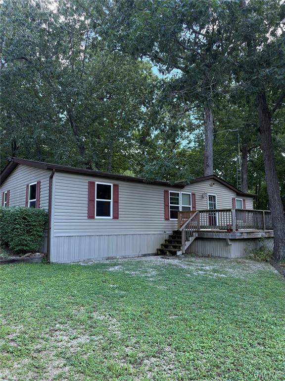 Permanently attached mobile home on 3.75 park-like acres.  Home is in good shape from long time elderly resident; replacement vinyl windows; working septic and well.  Property has 4 car garage/workshop and double carport and 2 storage sheds.  With minimal paint and elbow grease this property will make a wonderful home for the new buyer.