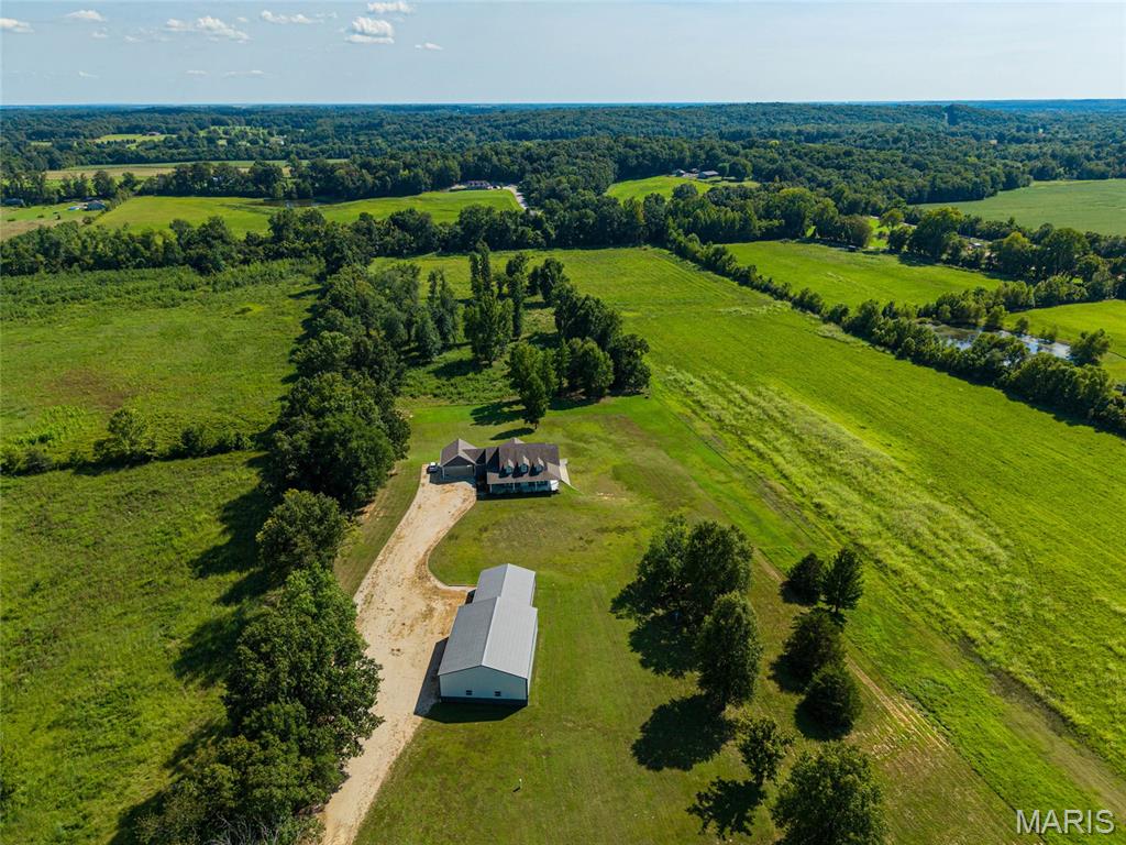 Whether your ideal lifestyle is filled with outdoor adventure or the comforts of familiar farm life, this exceptional property is ready to welcome you home!
Built in 2019, this custom 5-bedroom, 3.5-bath home sits on approximately 5 acres and offers an impressive blend of recreation, relaxation and low-maintenance living. Ideally located near Mingo National Wildlife Refuge and Duck Creek Conservation Area, the property has an additional 20+/- acres that features privately managed wetland habitat designed for waterfowl hunting. Complete with an irrigation system! The water control structure built into the levee system, making controlling the water levels easy. 

Inside, you’ll find custom cabinetry, granite countertops, geothermal heating and cooling, a mudroom, sunroom and a reinforced safe room with a built-in gun safe. The lower level provides additional living space and includes a convenient kitchenette—3 large bedrooms perfect for guests, extended family or entertaining.

Outside, enjoy the composite deck, durable Hardie Board siding and a massive 3,000+ square-foot shop that offers far more than equipment storage. The building currently accommodates a half-court gym where the kids can gather, a dedicated weight-room area and plenty of remaining space for farm equipment, ATVs, hunting gear, recreational vehicles and more.
This is more than a custom home—it’s a place to live, gather, hunt, work and enjoy the outdoors, all from one extraordinary property.