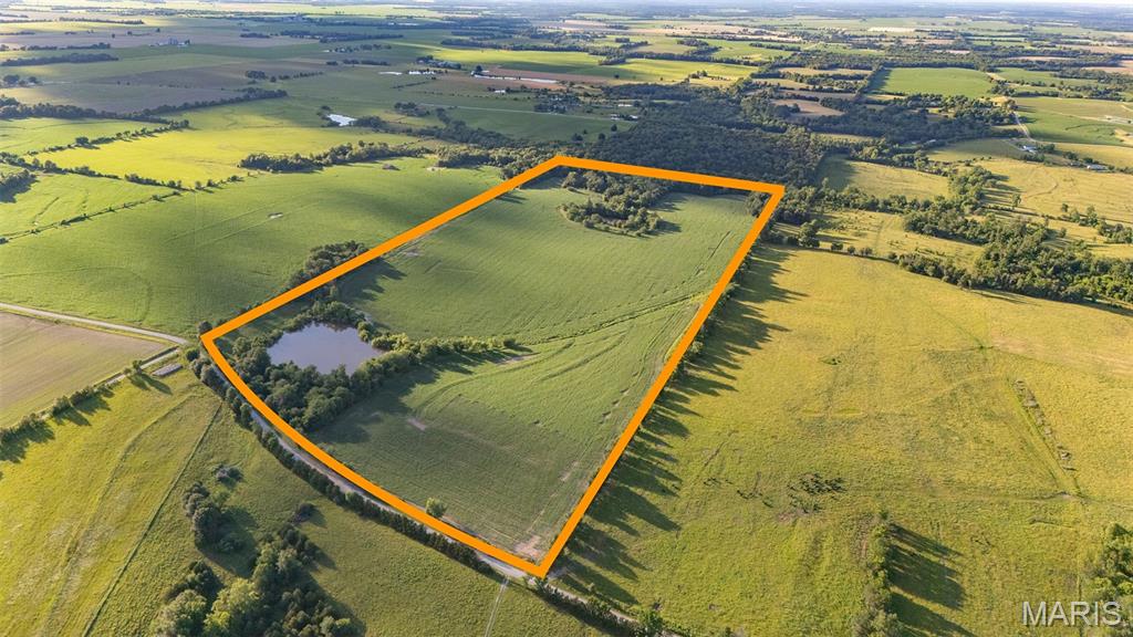 This beautiful 90± acre farm in Ralls County, Missouri, offers an outstanding combination of income, recreation, and future building potential. With approximately 65± tillable acres, the property provides a strong income-producing component while still offering excellent hunting and outdoor opportunities.

The farm features road frontage along the entire south property line, providing exceptional access and future flexibility. A gated entrance welcomes you onto the property, adding both privacy and convenience.

A scenic pond and a desirable building location make this property an excellent candidate for a future home, hunting cabin, or weekend retreat. The combination of productive farmland, water, and open views creates a setting that is both functional and attractive.

For the outdoorsman, this farm is in a highly desirable area known for quality deer hunting. The layout of the property is particularly well-suited for hunting north and west winds, allowing hunters to access and hunt the farm effectively while minimizing disturbance to wildlife.

Whether you are looking for an income-producing investment, a recreational getaway, or a place to build your dream home in the country, this Ralls County farm offers a tremendous opportunity.