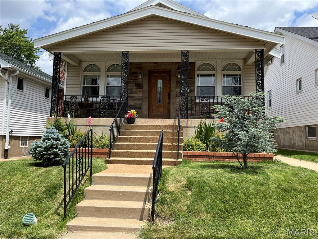 It's not just pretty, its expensive systems are updated! Enter from the inviting front porch into the lovely living room with stained glass. Next is the dining room and 2 nice sized bedrooms, one with stained glass. All show beautiful hardwood floors. The spacious kitchen has a bonus breakfast nook and stove hookup for gas or electric. There is an ice maker line. The unique ceiling fan in the living room and kitchen are focal points. The large bathroom has an exhaust fan, hard to find in older homes.  The walkout basement is partially finished with vinyl plank flooring; the space to be used as office,, recreation room or sleeping area at owners' discretion. The unfinished side has laundry hookups, a workbench, new HVAC and plenty of storage space. Access the new flagstone patio and the partially fenced gorgeous newly landscaped back yard from the porch off the kitchen. Upgrades done by current owner include: new roof, siding, HVAC, and more. Occupancy permit has been obtained!