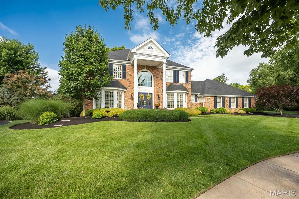 Welcome home to this beautifully updated 2-story in the sought-after Brookhill subdivision of Chesterfield! A dramatic two-story foyer with a graceful turned staircase sets the tone for the elegant yet comfortable living spaces throughout. Rich wood flooring spans the entire main level, while plantation shutters and three charming bay windows fill the home with warmth and natural light. Gather in the inviting family room featuring a gas fireplace with a raised hearth, flanked by custom built-in bookcases, and entertain with ease thanks to the convenient wet bar. This home flows effortlessly inside and out. The updated kitchen is a chef's delight with a center T shaped island, quartz counters, five-burner gas cooktop, tile backsplash, and newer KitchenAid wall oven and microwave with Air Fry and convection capability, offering style and functionality for everyday living. Step outside to enjoy a treelined, landscaped yard, the spacious deck, complete with a beautiful pergola and an adjoining patio—perfect for relaxing or hosting family and friends. Upstairs, the primary suite features a custom closet system, a spa-inspired bath with soaking tub, and an oversized shower with designer tile insets and built-in bench. The secondary bath offers a double-bowl vanity to easily accommodate busy mornings. Tastefully designed living space, exceptional updates, and timeless architectural details, this home offers the perfect blend of elegance, comfort, and everyday livability in one of Chesterfield's most desirable neighborhoods, on a very private and quiet culdesac lot. Inground sprinkler system, newer plush carpet, some new windows, and the custom front door will welcome you home for years to come.