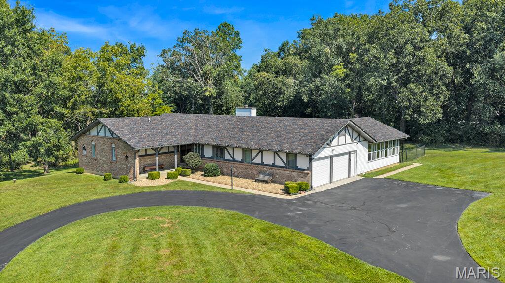 SPACE, PRIVACY & LOCATION—WITHOUT THE SUBDIVISION! This beautifully renovated ranch sits on 3.17 park-like acres just 2 miles from I-70, offering the privacy and breathing room without sacrificing convenience. Featuring 3 bedrooms, 3 full baths and approximately 2,300 sq. ft. of living space under air which includes the beautiful all-season room addition, this home is truly turnkey and move-in ready. Extensively renovated over the past five years, improvements include a new kitchen, updated baths, new septic system, roof, siding, HVAC system, all-season room, partially fenced backyard and so much more. A full basement provides future potential for additional living space, recreation, storage or future expansion. Enjoy peaceful acreage, mature surroundings and room between neighbors while remaining minutes from major highways, shopping, dining and everyday conveniences. This is the rare combination of privacy, acreage, location and a fully renovated home—all in one property.