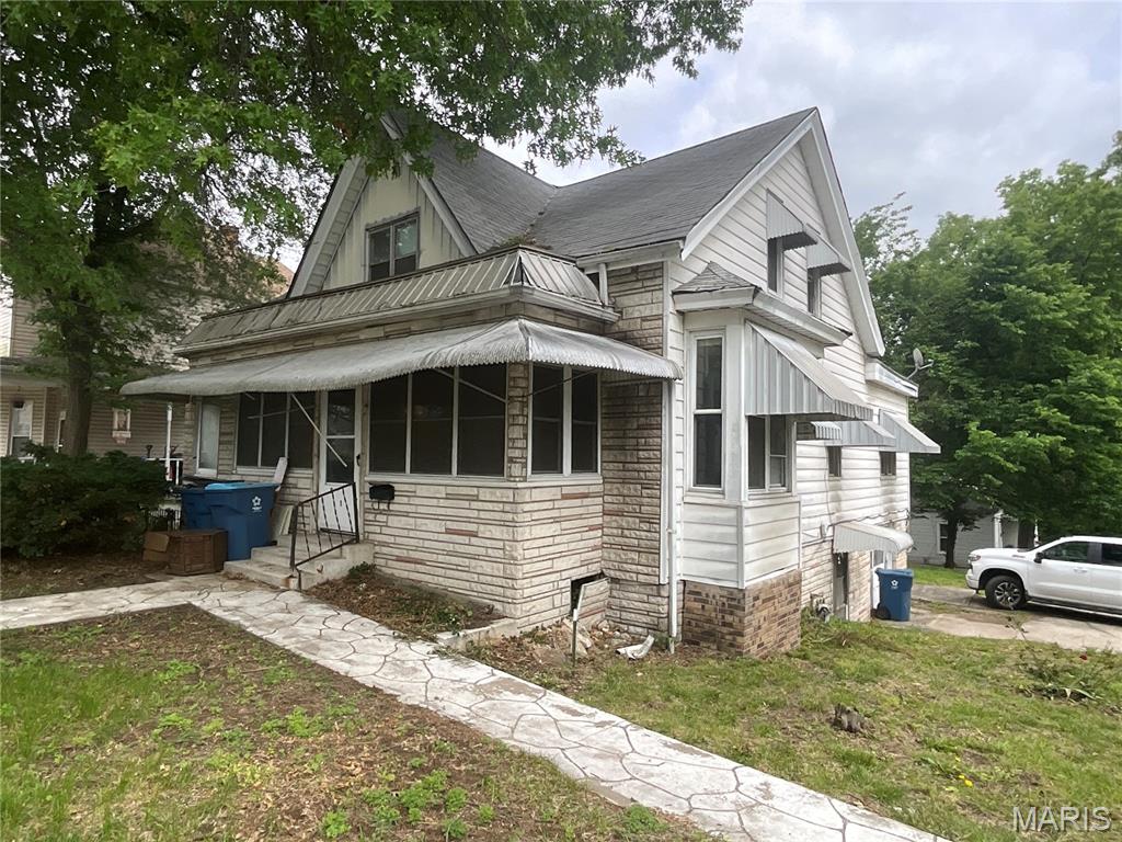 **Investor Opportunity on a Corner Lot in Alton!**
Located on a corner lot in Alton, Illinois, this unique property offers plenty of space, character, and potential. Currently being sold as a single-family residential structure, the home has a layout that may offer flexible living arrangements, with prior use suggesting possible multi-unit potential. Buyers should independently verify zoning and permitted uses with the appropriate local authorities.

The main portion of the home features hardwood floors, a spacious living area, dining room, large eat-in kitchen, and multiple bedrooms and baths. Additional areas include a small lower-level one-bedroom apartment-style space, a basement area previously set up with apartment-style features, an enclosed front porch, enclosed rear porch, and a one-car built-in garage.

Recent updates within the past six years include a furnace, insulation, air conditioning, and water heater, all added with energy efficiency in mind. The home also features a full basement, a unique stone foundation, and a stone fireplace in the backyard that adds character and charm.

This property is in need of renovation and rejuvenation, and it is priced accordingly. A great opportunity for someone with vision to bring this large, character-filled Alton home back to life.