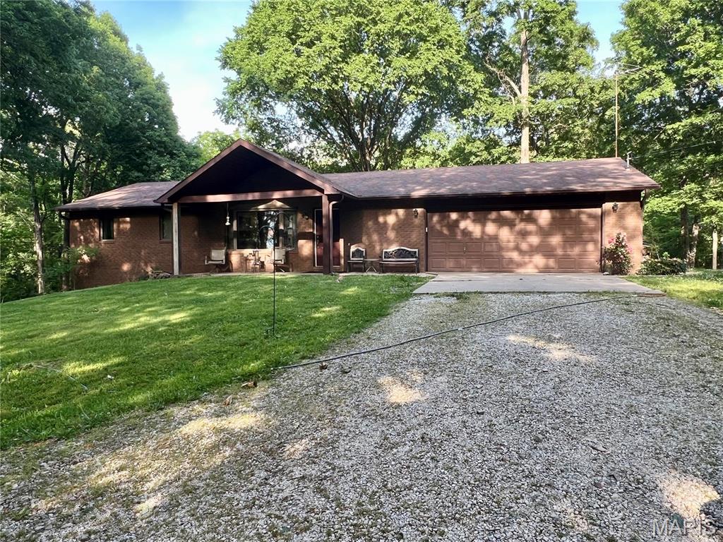 Mini farm potential on 5 scenic acres in Jackson with no HOA! This raised ranch offers 3 bedrooms, 3 bathrooms, plus a bonus room and walk-out basement. Main level features hardwood floors, wood-burning fireplace, attached 2-car garage, and spacious kitchen/living spaces. Primary suite includes walk-in closet, en suite bath, and private access to the large back deck overlooking mature trees. Lower level includes 1 bedroom, 1 bathroom, bonus room, John Deere room, and walk-out access. Immediate backyard is fenced with chain link. Property includes multiple outbuildings including a 21’x30’ pole barn, 14’x32’ insulated shed, fenced livestock area with structure, and old chicken coop. Previously used as a mini farm. Peaceful setting with room to spread out while still being conveniently located near Jackson amenities.