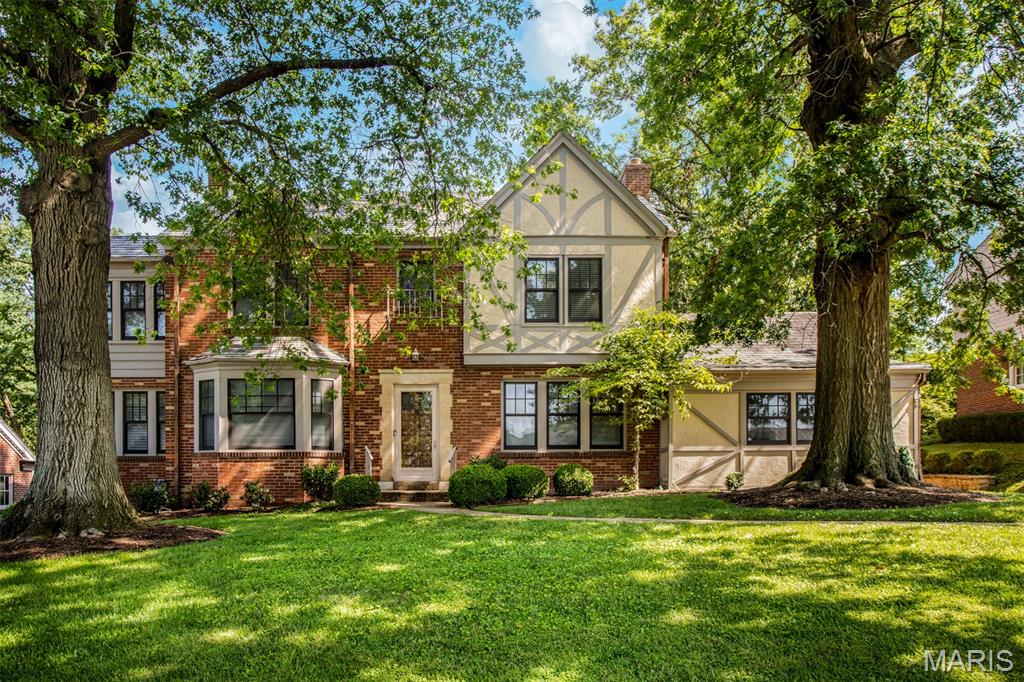 27 Thorndell is a Richmond Heights classic that’s equal parts timeless and full of life. Lovingly maintained by one family for 55 years, it’s easy to see why they never wanted to leave. The curb appeal alone could win awards, with lush landscaping and a front yard that looks straight out of a storybook. Step inside to find original parquet flooring, crown moulding, and woodwork that reminds you they really don’t build them like this anymore. The foyer leads you to the beautiful staircase or one of the many gathering spaces throughout the home. The formal living room is bright and welcoming, complete with built-ins and a timeless fireplace. Just off of it sits the bonus-office room, wrapped in rich wood paneling and a textured linen wall, practically begging for a vintage Ralph Lauren moment. The formal dining room features bay windows, detailed wallpaper, and a chandelier that was definitely made for dinner parties. Two sets of louvered doors lead you either to the kitchen or the show-stopping sunroom, where detailed walls and endless windows let the light pour in. The breakfast room and kitchen bring function and charm together with white cabinetry, stainless appliances, and a sub-zero fridge that means business. Nearby, the powder room features a hand-painted mural by local artist John Joseph Hunn; a true work of art. Another dining space and living area with vaulted ceilings, exposed beams, and floor-to-ceiling French windows gives off total coastal-granddaughter energy. It’s light, breezy, and the perfect setup for hosting. Upstairs, the primary suite includes a walk-in closet and ensuite bath with original brass hardware that’s vintage in all the right ways. Two additional bedrooms each feature sunroom nooks that make perfect offices, playrooms, or just quiet retreats. The lower level feels like a movie set, with pristine wood paneling, a fireplace, and a half bath. Laundry, workshop, and walkout included. Outside, the patio, iron fencing, and manicured gardens make entertaining easy. Plenty of green space for kids, dogs, or that t-ball league you swore you’d start. This home has heart, history, and just the right amount of personality. Come see why it’s so special. Cheers!