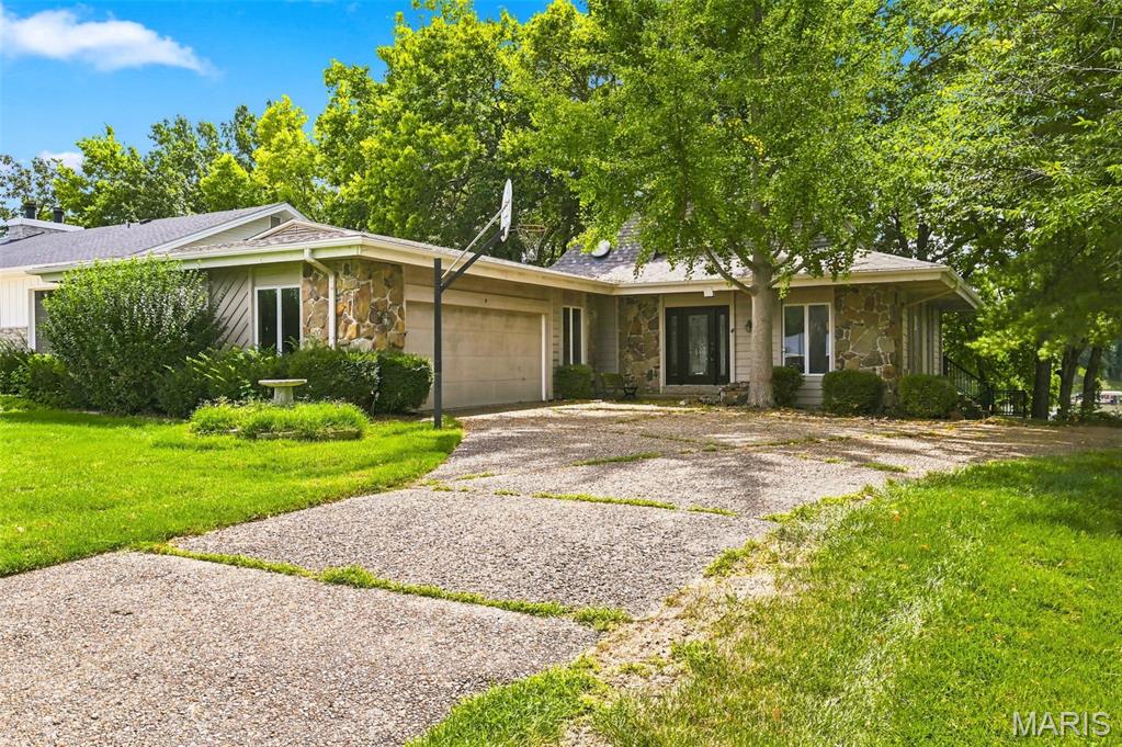 A Rare Opportunity on the BIG Lake in Lake Saint Louis! Bring your vision and create something truly special with this spacious waterfront home tucked inside a deep no-wake cove with beautiful sunset views. Surrounded by impressive waterfront properties, this home offers an incredible opportunity to update, personalize and make it your own while enjoying the Lake Saint Louis lifestyle.  The open floor plan was designed around the water, with lake views extending from the entry foyer through the Great Room, Dining Room and Kitchen, and three of the four bedrooms have stunning lake views. The open floor plan has a Great Room that features a gas fireplace, coffered ceiling and wood beams, while the Kitchen offers a center island and plenty of possibilities for a stunning transformation. Two generously sized bedrooms on the main level share a Jack-and-Jill bath.  Upstairs, the private Primary Suite includes a large walk-in closet and spacious En Suite with an oversized vanity, private water closet, soaking tub and separate shower.  There is also a waterfront balcony off the primary bedroom!  The Walkout Lower Level offers even more potential with a stone-front, raised-hearth wood-burning fireplace, rough-in for a wet bar, Bedroom #4 is framed, a framed and rough-in for an additional full bath, and a large Laundry/Storage Room.  Outside is where this property truly shines! Enjoy the water views from the newer maintenance-free wraparound deck, newer steps with handrail leading toward the lake make it an easy walk, a wooden boardwalk, seawall and private maintenance-free dock greet you at the water.  An impressive 29' wide x 23' deep garage provides exceptional space for vehicles, lake toys and storage.  Whether you renovate a little or reimagine it completely, opportunities like this on the BIG Lake don't come along often. Come for the house and beautiful waterfront lot, stay for the sunsets, the water views, and everything that makes Lake Saint Louis special.  This isn't just a home—it's a Lake Saint Louis Lifestyle!  This home is being sold as-is. Seller to make no repairs nor provide any inspections.  AS-IS Estate Sale Property