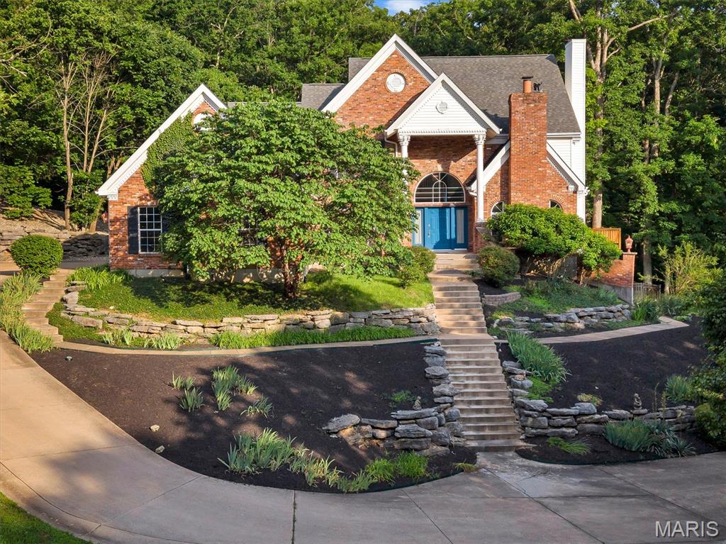 Some homes are just houses. This one is something else entirely. Tucked in nature, sitting on 2.72 private, wooded acres in the sought-after Osage Hills subdivision, 144 Cherokee Court is a one-of-a-kind custom retreat where every detail was crafted with intention — and where life simply feels better. From the moment you arrive, the tone is set. A stunning 2-story foyer welcomes you with bright white porcelain floors, soaring ceilings, and architectural details that whisper quality at every turn. Natural light pours in, mature trees frame every window, and the outside world quietly falls away. The heart of the home is a kitchen built for living — 42" cabinets, granite counters, hardwood floors, double wall ovens, Bosch dishwasher, a generous island, and a walk-in pantry. A fireplace just off the breakfast room makes morning coffee feel like a ritual. The formal dining room with gleaming hardwoods is ready for the holidays you'll want to host here for years to come. When the day is done, retreat to your en-suite primary bedroom where a wood-burning fireplace and private deck overlooking the trees make unwinding effortless. Downstairs, the fun truly begins. The finished walk-out lower level is an entertainer's dream — wine cellar, media room, full wet bar, and pool table included. Step outside to a private patio with waterfall, where evenings stretch long and guests never want to leave. For the car enthusiast, hobbyist, or anyone who simply needs space: a 4-car attached garage, 36x24 detached garage and workshop, plus an RV parking pad. Over 6,600 sq ft, 6 bedrooms, 5.5 baths, two masonry fireplaces, and a $100/year HOA that's almost easy to forget exists. Minutes from I-44, Wildwood, and everything Pacific has to offer — but once you're home, you won't want to leave.