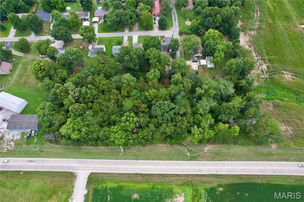 Approximately 2.12 wooded acres consisting of four unimproved lots along Veterans Memorial Drive in Mt. Vernon. Zoned residential and located near established residential areas, local businesses, and everyday conveniences. The property is undeveloped, allowing a buyer to explore the possibilities for the land based on their intended use. No utilities are currently in place. Acreage does not include the 17th Street right-of-way through Parcel 11-06-226-013. Buyer should verify access, zoning, utility availability, building requirements, property boundaries, and suitability for intended use.
