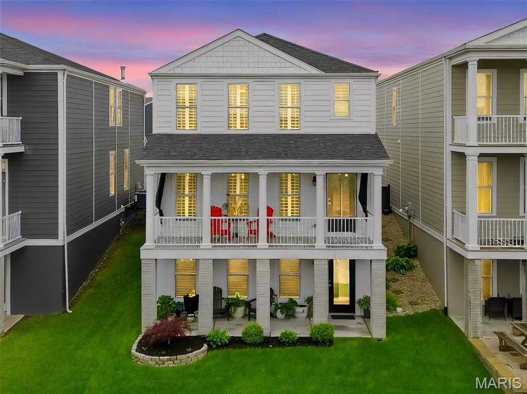 Immaculate Waterfront New Town Living with Double Balconies & Walkout Basement! Welcome to this beautifully updated 4-bedroom, 3.5-bath, finished basement home. The main level showcases wide plank flooring, updated lighting, and plantation shutters throughout & a updated powder room. The heart of the home is the stunning kitchen, complete with a large center island surrounded by cabinetry, white custom cabinets, marble countertops w/ single sink basin, and custom walk-in pantry. Upstairs, the luxurious primary suite features plantation shutters, a custom walk-in closet, and a barn door entrance leading into the bath with a dual vanity and stand-alone shower. A loft area, 3 add'l bedrooms—one with a walk-in closet—a hall full bath, linen closet & convenient laundry area complete the upper level. The finished walkout lower level is designed for entertaining, offering a large rec room, a custom serving area with wine cooler/refrigerator, separate sink station, and bathroom w/ shower. Step outside to enjoy the ultimate waterfront lifestyle. The fenced backyard is perfect for pets and gardening, while the canal just beyond invites you to fish, swim, float, kayak, or paddleboard right from your own backyard. A 2-car garage and extended driveway provide ample parking and convenience.  New Town has a lifestyle that feels like a vacation every day!