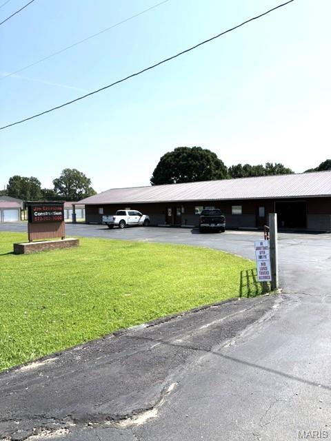 Instant income with this 96 unit mini storage property.  It also has a living quarters on it or it could be converted to climate controlled units.  There are also two other office units.  One is currently a Barber Shop and the other is an office space with a 1/2 bath.  The owner presently resides in the living quarters and they operate the Barber Shop.  There is also a shop room and extra storage in the main building.  There is a stocked pond and it all sits on 3+ acres.  There are so many possibilities with this property.  Call today for a tour.