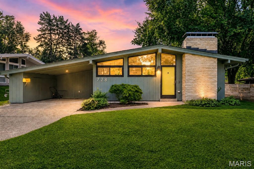 A truly exceptional example of St. Louis mid-century modern architecture, this beautifully renovated Ridgewood home was designed and built by the celebrated duo of architect Ralph Fournier and builder Burton Duenke. Thoughtfully reimagined while honoring its original California ranch character, the home combines warm, organic materials, beautiful proportions and authentic MCM design with the comfort and function of a thoroughly modern renovation. A reconfigured floor plan creates an effortless connection between the main living spaces and the expansive family room, while a second living area offers flexibility for relaxing or entertaining. Nearly every element has been addressed, including new hardwood flooring, complete electrical rewiring and upgraded panel, plumbing improvements, HVAC upgrades, insulation, drywall and paint, replacement of nearly all windows, new lighting and ceiling fans, and new doors, freshly stained in a warm wood tone. Newer roof ('21), water heater ('20) and HVAC ('15). The great room is a showstopper, with clerestory windows, vaulted ceiling, a dramatic fireplace and abundant natural light. The stunning new kitchen features custom cabinetry, marble and quartz countertops, new appliances and a striking tile backsplash, with the newer refrigerator included. The two beautifully designed baths feature large-format terrazzo tile and thoughtfully selected custom finishes, including a newly added second bath that enhances the home’s functionality. The spacious laundry room is equally impressive, with beautiful terrazzo tile flooring and a brand-new washer and dryer included. The family room features a custom dry bar with quartz countertop, tile backsplash and dedicated outlet for a beverage refrigerator, plus a wall of windows overlooking the level, fenced backyard with a nice patio and refreshed garden beds. Two EV chargers and additional storage are located in the carport. An exceptional renovation that respects the architecture while making the home even better for today. This is MCM done right!