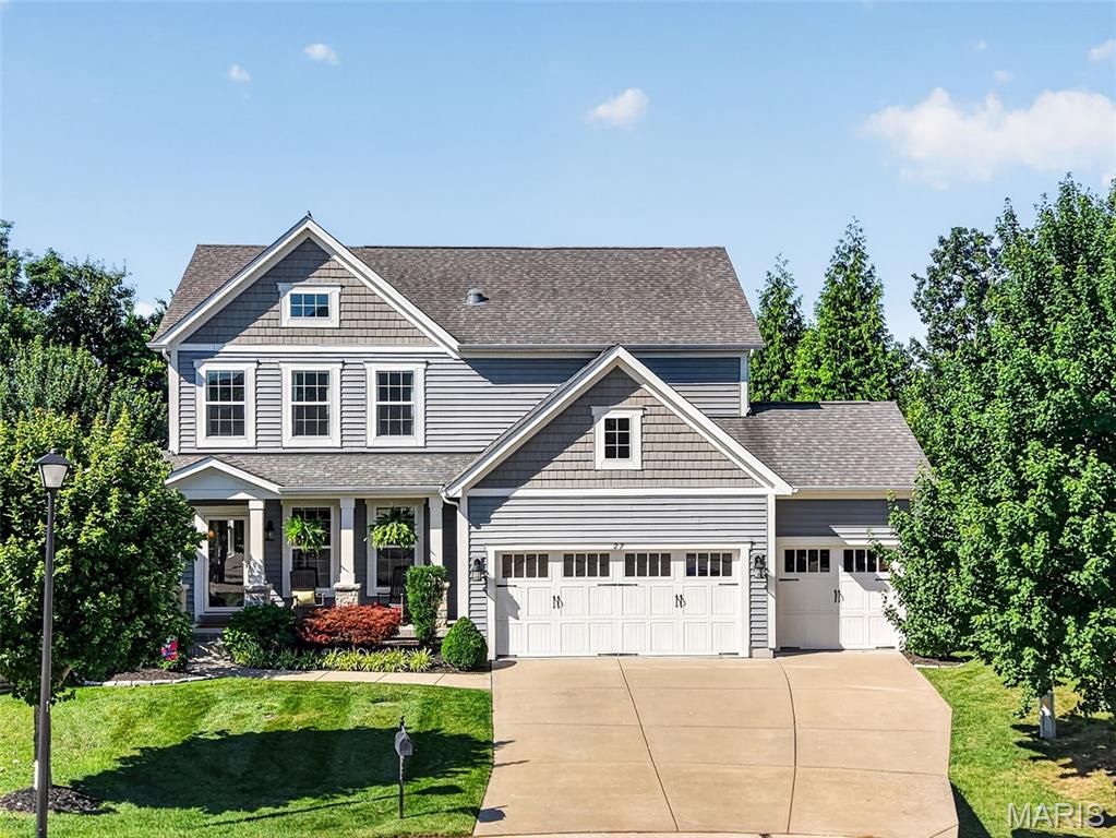 Welcome home to this stunning two-story residence in the highly sought-after Countryshire community of Lake St. Louis. Backing to mature trees and just steps from the neighborhood walking trail, this beautifully appointed home offers the perfect blend of luxury, comfort, and convenience.
The open floor plan features hardwood flooring throughout the main level and a spacious living room highlighted by a cozy gas fireplace and peaceful wooded views. The gourmet kitchen is sure to impress with custom white cabinetry, granite countertops, a center island breakfast bar, stainless steel appliances, subway tile backsplash, under-cabinet lighting, and seamless flow into the dining area—perfect for everyday living and entertaining.
Start your mornings on the 11x17 screened porch surrounded by nature, or unwind on the backyard paver patio. A private home office with French doors, custom mudroom with built-in bench and cubbies, powder room, and convenient access to the three-car garage complete the main level.
Upstairs, all four bedrooms feature walk-in closets. The spacious primary suite offers crown molding, dual closets, and a luxurious bath with dual vanities. A bright loft with abundant windows and recessed lighting provides flexible space for a media room, playroom, or gaming area. An additional full bath and upper-level laundry add everyday convenience.
The finished lower level expands your living space with a large family room, rec room, and versatile bonus room ideal for a home gym, hobby room, or guest space. Thoughtful upgrades throughout include board and batten accents, framed windows, crown molding, neutral décor, and an irrigation system.
Residents of Countryshire enjoy exceptional amenities including walking trails, playgrounds, picnic areas, a community pool, and sports courts. Conveniently located within walking distance of local schools and just minutes from shopping, dining, and easy access to Highways 40/64 and 364. 
From the wooded backyard views to the resort-style neighborhood amenities, this home truly has it all. Come see for yourself.