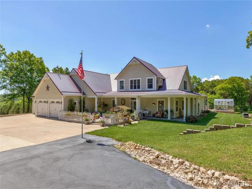 Discover the perfect blend of modern comfort and rural tranquility at 1068 State Hwy 47.  Built in 2009, offers 3,606 square feet of thoughtfully designed living space on a sprawling 7+ acre lot.  Step inside this unique 1.5-story residence featuring 4 bedrooms and 3.5 bathrooms.  The open layout includes a dramatic two-story entry foyer, a cozy fireplace, and versatile spaces with tile, carpet, and hardwood floors.  The large master suite features double vanities, and enclosed shower, and a convenient laundry facility.  On the top floor notice 2 large bedrooms, a full bath, and large bonus room for gaming or learning.  Also, the walk-out lower level is partially finished with a sleeping area and full bath.  The attached 3-car garage provides convenient parking.   Outside, enjoy the peaceful acreage with a deck, patio, and even a greenhouse—ideal for gardening enthusiasts or those seeking a self-sufficient lifestyle. The metal roof adds durability and distinctive charm to this eye-catching gabled design.  Other bonus features include a chicken coop, 2 propane tanks, and emergency generator for non-stop electricity.  Nestled in the heart of Missouri's countryside, yet conveniently located just off Highway 47 near Bonne Terre, this property offers easy access to local attractions like the historic Bonne Terre Mine with its underground lake tours, St. Francois State Park, and outdoor adventures. Commute to St. Louis is approximately 1-hour away.  Whether you're looking for a private family retreat, hobby farm potential, or a peaceful escape with room to roam, this home delivers endless possibilities.  The massive driveway can help with future boat or RV parking.  Walking trails through land in back yard.
