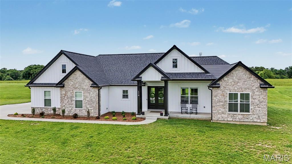 Situated on 3.15 acres, this custom ranch offers the perfect combination of space, privacy, and thoughtful design. With an open-concept layout and custom finishes throughout, this home was designed to accommodate both everyday living and entertaining.

The main living area features an impressive 11-foot stepped ceiling in the great room, expansive windows, and a floor-to-ceiling stone fireplace. The spacious kitchen offers an oversized island, double ovens, and a walk-in pantry complete with built-in cabinetry and countertop workspace, creating a natural gathering place for family and friends.

The split-bedroom layout includes three main-level bedrooms, each with its own walk-in closet and private bathroom. The primary suite features dual vanities, a beautifully tiled shower, and an oversized walk-in closet. The finished lower level continues the home’s spacious feel with 9-foot ceilings, a second primary suite with an attached full bath, a fifth bedroom, a large recreation area, bar rough-in, and private garage-to-basement access, making it ideal for guests, extended family, or multi-generational living.

Additional features include dual water heaters serving separate areas of the home, an oversized garage, and an additional washer and dryer hookup in the lower level. Outside, enjoy a covered patio and plenty of open space for recreation, outdoor entertaining, a future pool, or shop.

Move-in ready and meticulously maintained, this custom home offers comfort, functionality, and modern convenience while remaining just minutes from town.