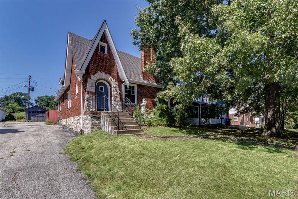 Classic brick Tudor charm, generous living space, and plenty of potential in University City! Offering approximately 1,725 square feet, this 3-bedroom home features hardwood floors throughout the main level and plenty of the architectural character you hope to find in a home of this era. The spacious living room is anchored by a wood-burning fireplace and flows through an arched opening to the separate dining room. Two generously sized main-floor bedrooms feature large windows and abundant natural light, while the full bath offers convenient linen storage. The kitchen is equipped with stainless steel appliances, a gas range, microwave, dishwasher, and disposal. Upstairs is where this home really surprises—a huge, open family/bonus room offers an impressive amount of flexible living space, along with a separate third bedroom. There's plenty of room for a home office, studio, recreation space, or whatever suits your needs. Outside, you'll find a fenced backyard, off-street parking, and a detached one-car garage. Central air was replaced in 2022. All of this is tucked away on a short, quiet dead-end street. With its distinctive architecture, spacious floor plan, and nearly 1,725 square feet of living space, there's plenty here to make your own.