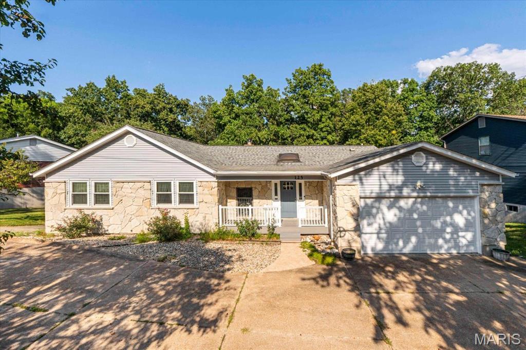 Step into a sanctuary of quality, space, and thoughtful design at 125 Strecker Road. Tucked away on a picturesque lot backing to peaceful woods, this pristine ranch home seamlessly blends daily comfort with remarkable versatility. Inside, an open and inviting floor plan unfolds, anchored by a cozy living room fireplace. Culinary enthusiasts will adore the kitchen, equipped with a gas range, refrigerator that stays with the home, convenient breakfast bar for quick bites, and a bright breakfast room for casual dining. Just off the living room, sunlight streams into the sunroom, equipped with a ceiling fan, making it the perfect spot for relaxing with a morning coffee. The layout offers 3 spacious bedrooms and 2 full baths, including a primary bedroom suite designed for ultimate comfort, featuring a soaking tub and walk-in closet. Pamper yourself on chilly mornings with cozy radiant floor heating installed in both the primary suite and one of the secondary bedrooms. Main-floor living is made effortless with washer/dryer hookups discreetly located in one of the secondary bedroom closets. Make your way downstairs to explore the partially finished walkout basement. Designed for maximum flexibility, this lower level features a secondary living room, a convenient half bathroom, an abundant unfinished space for storage or future workshop projects, and another refrigerator. Transition outside to your fully fenced backyard oasis backing directly to the woods. Enjoy front-row views of nature from the newer covered composite deck. Automotive enthusiasts, hobbyists, or storage seekers will fall in love with the garage capabilities: beyond the main 2-car garage and long extended driveway, the lower level features an expansive "tuck-around" garage, giving you space and options to park up to 5 cars total! Major peace-of-mind updates highlight true pride of ownership, including a newer roof, siding, gutters, downspouts, skylights, sunroom roof, and water heater, plus a smart thermostat.