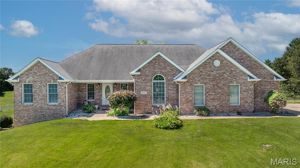 Welcome to 1537 County Road 618, where peaceful country living meets exceptional comfort and space. Situated on 3.53 scenic acres in the desirable Wild Horse Creek subdivision, this all-brick ranch offers almost 5,000 square feet of finished living space with breathtaking views and room to spread out.

Featuring 5 bedrooms and 3 full bathrooms, this split-bedroom floor plan provides privacy and functionality for everyday living. The spacious kitchen is equipped with granite countertops, stainless steel appliances, and a breakfast bar, flowing seamlessly into the dining and living areas. Hardwood floors and a cozy gas fireplace add warmth and character throughout the home.

The finished walk-out basement expands your living space with a large family room, additional bedroom and bath, ample storage, and endless possibilities for recreation, entertaining, or multi-generational living.

Outside, you’ll enjoy the beauty of a white-fenced property, mature landscaping, and plenty of open space for outdoor activities. The attached side-entry two-car garage, main-level laundry, and private setting make this home as practical as it is beautiful.

If you’ve been searching for acreage, stunning views, and a spacious move-in-ready home just minutes from Cape Girardeau and Jackson, this is one you won’t want to miss.
