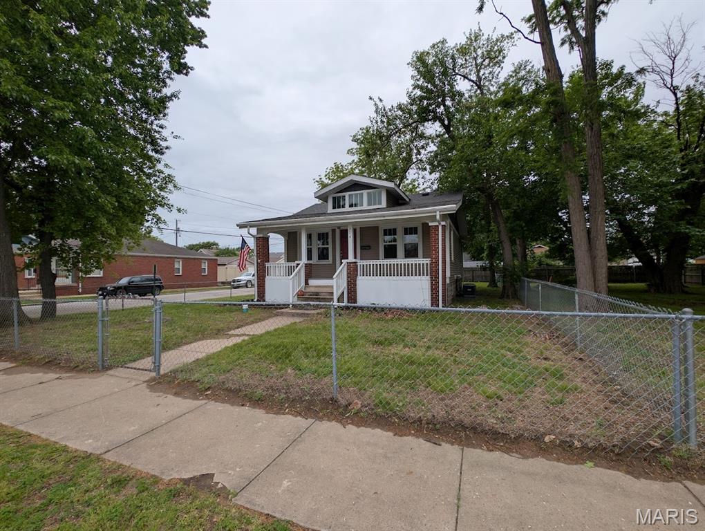 Corner lot remodeled bungalow with 21'x6' covered front and 7'x7' back porch. Fully fenced front and back yard. New architectural roof and siding and soffit and fascia and thermal windows and electrical in '18. Updates in '26 new bath vanity and toilet and LVP flooring. Freshly painted interior and basement. New kitchen island cabinets and countertops and sink and faucets. Large walk-in pantry. New ceiling fans and light fixtures. But with all the updates still has the historic charm of the original woodworks and glass atrium doors between the living and dining room. All kitchen appliances stay. Adjacent vacant lot can also be purchased for an additional $14,900. Choice Home Warranty included at asking price of $159,900. Agent Owned property.