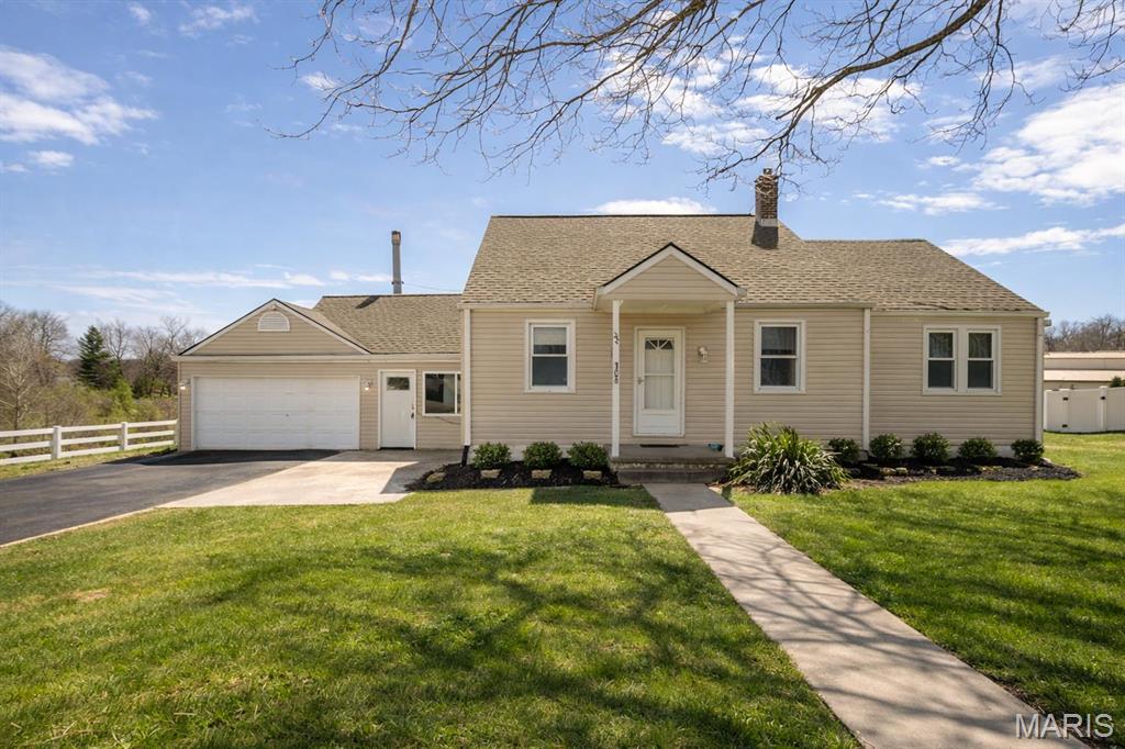 Tucked away on nearly 3 private acres, this charming 2-bedroom, 2-bath home offers the perfect blend of peaceful country living and unbeatable convenience—just 5 minutes from all the shopping, dining, and entertainment in Fairview Heights and less than 30 minutes from Scott Air Force Base. The property features a mix of open pasture ideal for horses, a wooded area for added privacy, and a spacious roundabout driveway for easy access and curb appeal. Inside, you’ll find a bright and inviting layout highlighted by a large climate-controlled sunroom, perfect for year-round enjoyment. The home also includes an unfinished basement offering additional storage or potential future living space. For equestrian enthusiasts, the large horse barn with multiple stalls makes this property truly stand out. A rare opportunity to enjoy space, seclusion, and location all in one! Buyer or buyer's agent to verify all MLS info.