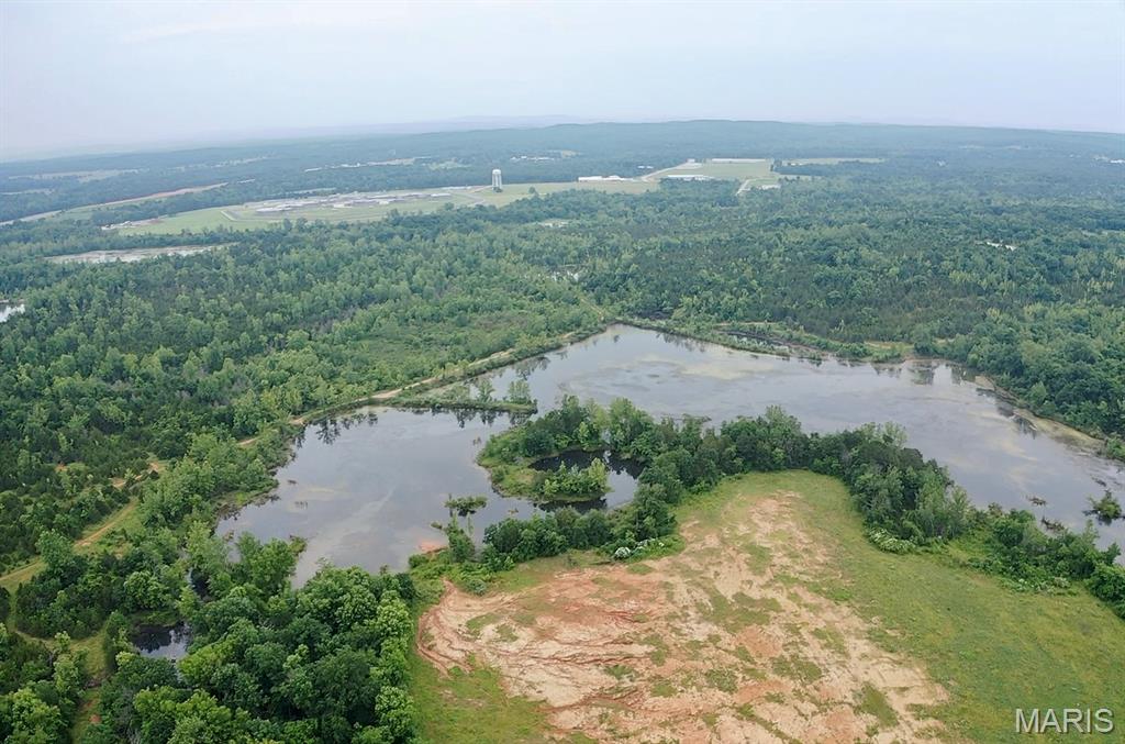 Discover a rare and expansive opportunity just 5 minutes from downtown Potosi! This large, unrestricted parcel offers a versatile blend of open pasture and hay fields, mature timber, recreational land, and a breathtaking private lake spanning over 20 acres. With approximately 40+/- acres of open ground, the property is ideal for farming, custom home building, development, or outdoor recreation. The large easternmost field is currently used for hay production, while the wooded section along the road has strong potential to be cleared and returned to pasture. The southeastern portion, lying below the lake dam and access road, is perfect for recreational use—think camping, hiking, or simply enjoying nature. The northern and southwestern areas are buildable, offering plenty of space for a home, cabin, or lodge. Public sewer is available near the southwestern edge, and electric runs through the northeastern corner. Best of all, there are no restrictions, giving you complete freedom to use the land as you choose. Whether you're looking to build your dream retreat, run livestock, develop multiple homesites, or enjoy your own private lake and abundant wildlife, this property is full of potential in a peaceful and accessible location.