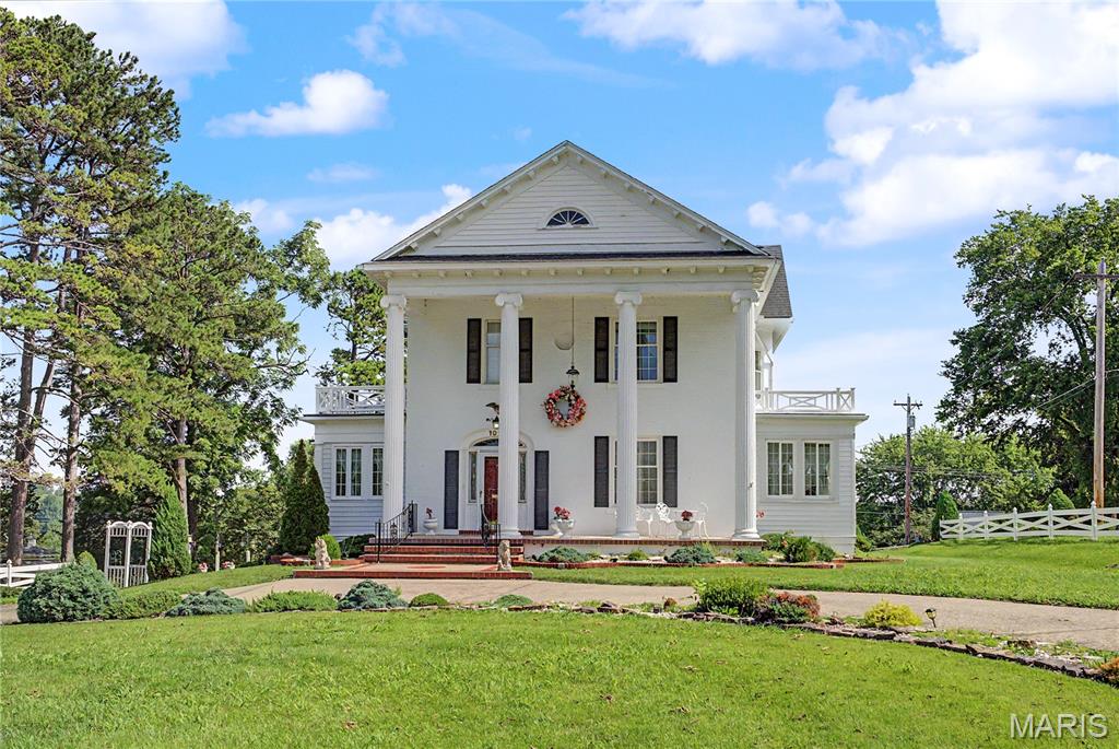 Welcome to 1022 Woodland Drive, where history, elegance, and family memories come together in one extraordinary home. Built in 1905, this stately white two-story residence is a rare treasure, offering more than 3,300 finished square feet of timeless beauty on 1.92 picturesque acres.

From the moment you arrive, you'll be captivated by the home's commanding presence and classic architecture. Step inside and be transported to an era when homes were built with exceptional craftsmanship and attention to every detail. Rich original woodwork, soaring ceilings, oversized windows that flood each room with natural light, elegant moldings, and a breathtaking grand staircase create a first impression that is nothing short of unforgettable. The warmth of the home's fireplace invites family and friends to gather, making every season feel special.

Designed with both everyday living and entertaining in mind, the spacious floor plan offers generous rooms where holidays are celebrated, milestones are remembered, and traditions are passed from one generation to the next. The breakfast nook is the perfect place to begin each day, with a charming side porch just steps away—an ideal spot to sip your morning coffee while listening to the birds and enjoying peaceful views of the property.

An attached garage, basement, and abundant storage ensure this historic masterpiece offers the conveniences today's homeowners expect while preserving the architectural charm that makes it truly one of a kind.

Outside, nearly two acres of beautifully maintained grounds provide endless opportunities for children to play, pets to roam, gardens to flourish, and family gatherings to grow. The attractive white vinyl fencing frames the property beautifully, while the detached gazebo offers a peaceful retreat for relaxing evenings, outdoor dining, or quiet moments surrounded by nature.

Adding incredible versatility is the impressive carriage house, featuring a two-car garage on the main level and a finished upper level that can easily become the ultimate game room, hobby space, home office, fitness studio, art room, or the perfect man cave. Whether you're storing classic cars, creating a workshop, or designing your dream recreation space, the possibilities are endless.

Homes like this are seldom available. If you've dreamed of owning a piece of Jackson's history—where every room tells a story, every gathering creates a memory, and every day feels a little more special—1022 Woodland Drive is ready to welcome your family home.