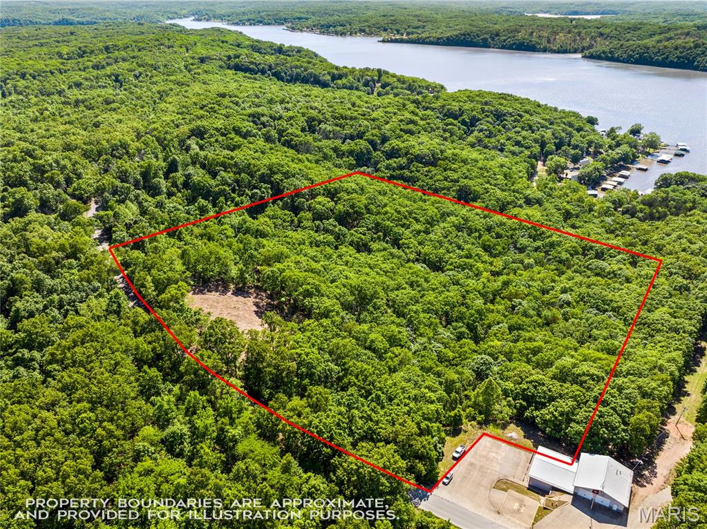 Perched above the Lake of the Ozarks with impressive views and a setting that feels truly special, this 11.31± acre tract on Wilson Bend Road offers a standout opportunity for a private homesite, lake-area retreat, or thoughtfully designed getaway. Recently cleared to better reveal the full potential of the property, the land now showcases a remarkable elevated building area with sweeping lake views and room to position a home to take full advantage of the scenery. Nearby electric and fiber internet makes building a breeze. The acreage provides a great blend of usable open space, mature timber, privacy, and the natural beauty that makes this stretch of the Lake so appealing. Located in the Wilson Bend area near the 52-mile marker, the property offers a peaceful rural feel while remaining within reach of lake conveniences, area attractions, and nearby Gravois Fire Protection District Station #3. Whether you are ready to build now or secure a quality lake-view acreage parcel for the future, this is a compelling piece of ground.