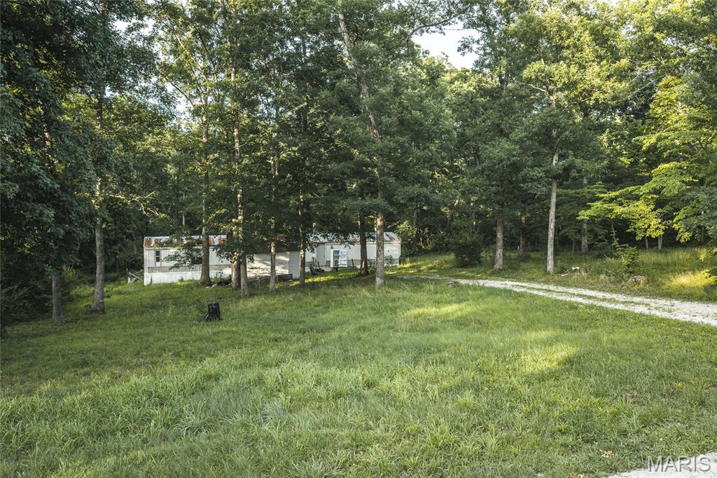 Discover the potential of this 3-bedroom, 2-bath mobile home on peaceful Abrolat Road in Warren County. Situated on a quiet gravel road, this property offers the flexibility to serve as a comfortable personal residence or a rental investment. Looking for even more opportunity? The seller is offering the option to purchase the five adjoining properties, making this an excellent chance to expand your investment portfolio or create your own multi-property homestead. Enjoy the privacy of country living while remaining just a short drive from Wright City and surrounding amenities.