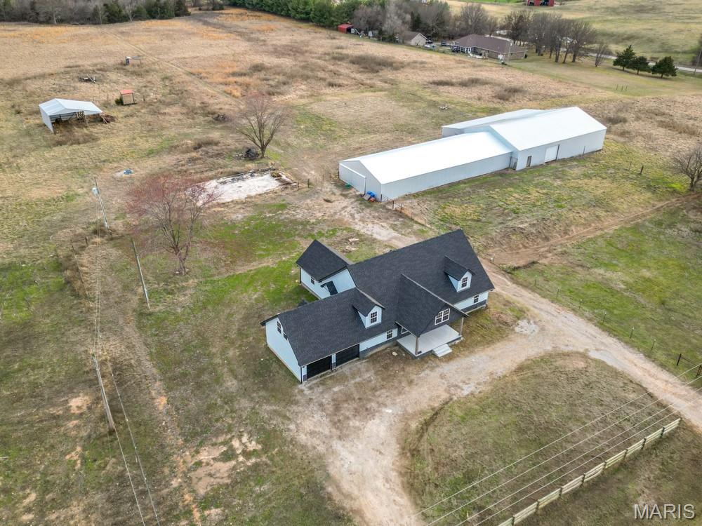 WELCOME HOME to YOUR NEW MODERN CRAFTSMAN STYLE HOME on 34 ACRES ML of  PASTURE LAND, CLOSE TO TOWN  On  BLACKTOP  with ROAD FRONTAGE on TWO SIDES. THIS 4 BEDROOM, 2 BATH, HOME has a  2 CAR ATTACHED GARAGE,  2209 SQ FT OF LIVING SPACE IT.s has  been TOTALLY REBUILT and UPDATED HOME IS
 VERY OPEN STYLE KITCHEN & LIVING ROOM COMBO,  LARGE CENTER ISLAND, ALL NEW WINDOWS,  SIDING, SHINGLES, GUTTERING, WIRING, PLUMBING, DRYWALL, TRIM, DOORS, INTERIOR PAINT, NEW KITCHEN CABINETRY, STAINLESS APPLIANCES, NEW UPDATED  BATHROOMS. W/NEW SHOWERS, TOILETS, SINKS-VANITY, NEW FANS & LIGHTING FIXTURES, THE MASTER BEDROOM IS SEPARATE FROM THE OTHER BEDROOM AREA  
 NEW CENTRAL HEAT & AIR,  ALL NEW SPLIT RAIL FENCING, TOTALLY REMODEL 2025
NOW,  LETS TALK ABOUT THE BARN...ITS A MASSIVE 80 X 66 OPEN ARENA, with ROOM FOR ALL OF YOUR  MACHINERY and  EQUIPMENT, PLUS AN  INDOOR RIDING ARENA.  LARGE HAY SHED.