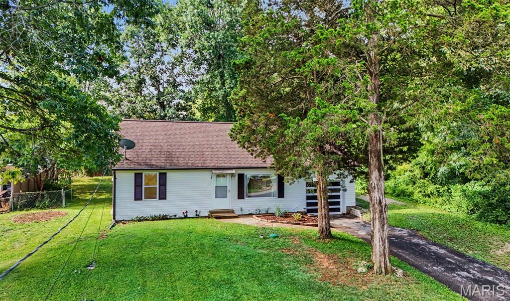 Showings start Friday, August 21. Tucked away in Fenton, this home offers a rare retreat where a sprawling, private backyard becomes an extension of everyday living, free from the constraints of an HOA and open to your imagination. Inside, the home unfolds with intention. The main level holds two comfortable bedrooms and a full bath, softly lit by a window that lets the daylight linger. Upstairs, the third bedroom claims the entire level as its own as a private escape suited just as well for a primary suite, a guest retreat, or a peaceful home office. The kitchen brims with warmth and character, dressed in newer cabinetry, rich wood countertops, and a fresh backsplash that ties it all together. Toward the back of the home, a four-seasons room catches the light in every direction, framing views of the backyard beyond and inviting you to linger there in any season. Beyond the walls, the backyard stretches out into a generous and secluded area. 118 Cherry Hill Dr isn't just a home, it's an invitation to slow down and settle in.