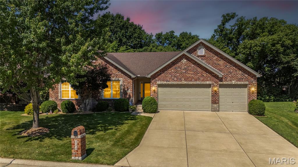 Stunning ranch-style home located in the sought after Manors at Meadowbrook subdivision in Lake Saint Louis! This home boasts 3 bedrooms, 3 full bathrooms, and over 3,600 square feet of living space including the finished lower level.

The front door opens to the entry foyer with a coat closet, tile floors, and crown molding. The living room features a stone and brick gas fireplace, wall of windows, built-in shelving with lighting, crown molding, and opens to the kitchen. 

The updated kitchen boasts newer quartz countertops, staggered cabinetry with crown molding, newer tile backsplash, newer stainless steel appliances, tile floors, center island with breakfast bar, newer Blanco sink, newer garbage disposal, walk-in pantry, crown molding, and dining area with a bay window. 

The primary bedroom features a tray ceiling and a luxurious bathroom which was updated in 2022. The bathroom features quartz countertops, a dual vanity, tile floors, walk-in glass shower with a tile surround and bench, and a walk-in closet. Two additional bedrooms, an updated full hall bathroom, and laundry room complete the main level. 

The finished lower level boasts a huge recreation room, two sleeping rooms, multiple storage rooms, and an updated full bathroom. Other highlights include: oversized 3 car garage with epoxy floors and fully dry walled, two panel arched doors throughout, ADT security system with 1 motion detector, Ring doorbell, newer sump pump, leaf gutters (2021), new AC unit (2019), new tankless hot water heater (2019), and new washer and dryer (2020). 

Relax outside on the spacious back patio with an epoxy finish and enjoy the spacious yard with extensive landscaping. Location could not be better – close to major highways, restaurants, shops, schools, and subdivision amenities including the subdivision pool, clubhouse, and tennis courts!