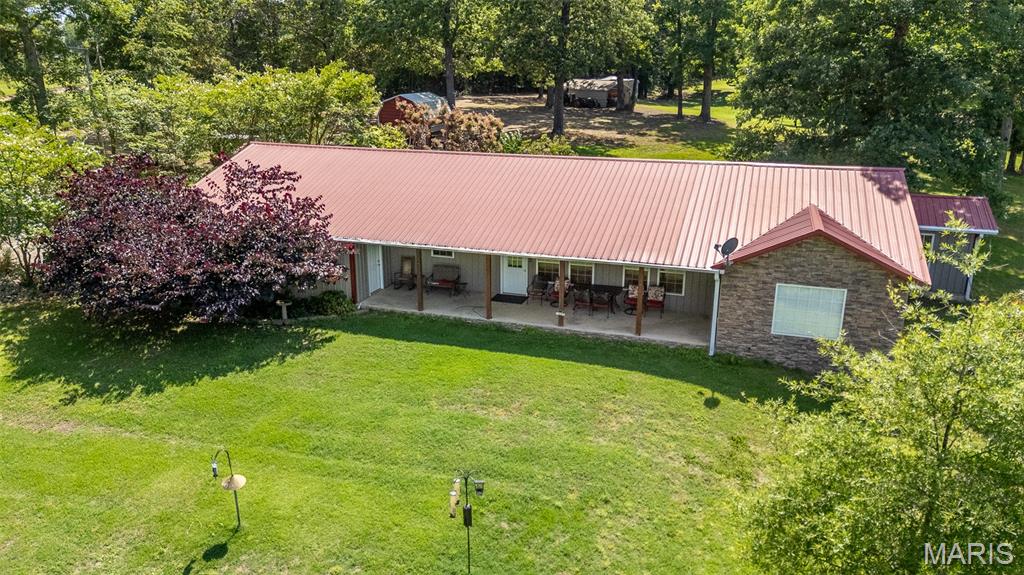 Stunning 4 bed, 2 bath home with a view of gorgeous Current River but well above the 2017 flood line. Home is in pristine condition and can be purchased with all of the furniture and appliances. Features hot tub and outdoor shower. Fantastic covered front patio overlooking the river with beautiful landscaping. Very low maintenance metal roof and siding! Huge attached garage with utility room and storage area. This home features approximately 1891 square feet - all on one level! This is your chance to enjoy a view of the river without fear or flooding.