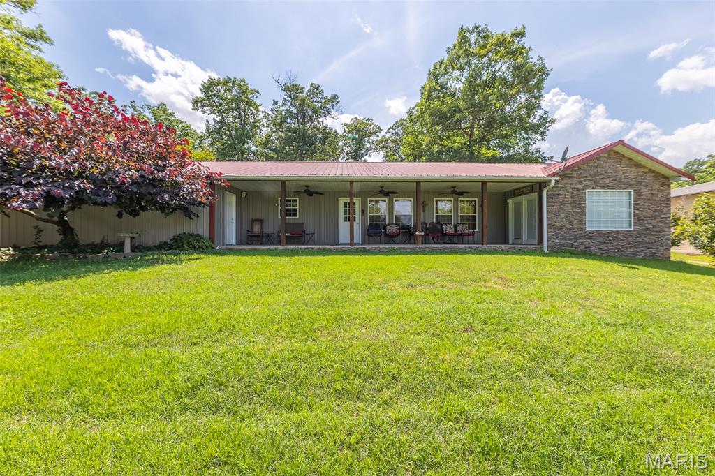 Stunning 4 bed, 2 bath home with a view of gorgeous Current River but well above the 2017 flood line. Home is in pristine condition and can be purchased with all of the furniture and appliances. Features hot tub and outdoor shower. Fantastic covered front patio overlooking the river with beautiful landscaping. Very low maintenance metal roof and siding! Huge attached garage with utility room and storage area. This home features approximately 1891 square feet - all on one level! This is your chance to enjoy a view of the river without fear or flooding.