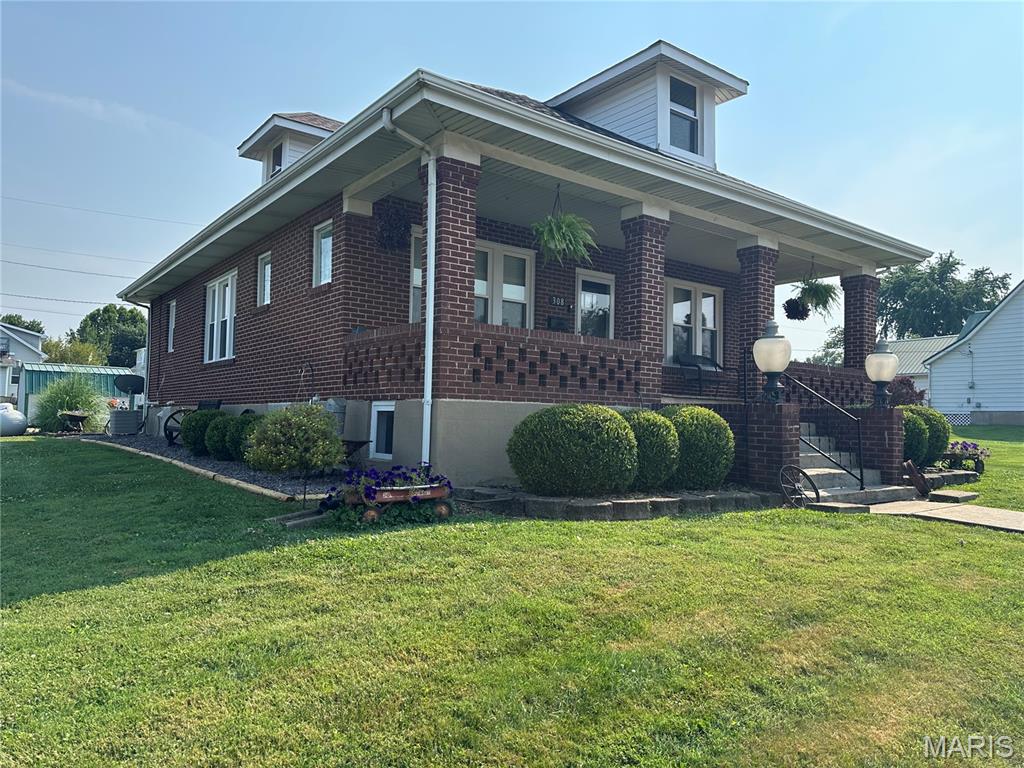 Step into timeless charm with this beautifully preserved brick Craftsman home, where classic character and exceptional craftsmanship shine throughout. Relax on the inviting covered front porch or unwind in the enclosed back porch, offering additional space to enjoy every season.
Inside, you’ll find a spacious and well-designed kitchen with abundant cabinetry and workspace—perfect for preparing meals, gathering with family, or entertaining guests. The main level features two comfortable bedrooms and one-and-a-half baths, while upstairs offers an additional bedroom and office/flex space, ideal for working from home, hobbies, or overnight guests. The rich wood floors are absolutely impeccable, and the stunning original millwork reflects the quality and craftsmanship these homes are known for. The beautiful stained-glass windows adds warmth and timeless appeal, creating a truly unique focal point. Outside, you’ll appreciate the meticulously manicured landscaping that enhances the home’s outstanding curb appeal. The beautifully maintained grounds provide a picturesque setting and reflect the same pride of ownership found throughout the home. Lovingly maintained through the years, this exceptional Craftsman home offers the perfect blend of historic charm, modern functionality, and enduring quality. If you’ve been searching for a home filled with character, warmth, and architectural beauty, this is one you simply must see.