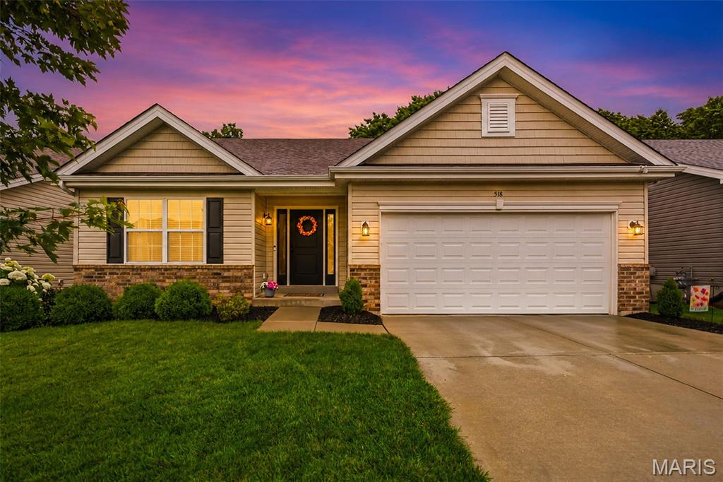 Tucked away on a quiet street near a cul-de-sac in desirable Brookside Forest, this beautifully maintained ranch offers the perfect blend of privacy, comfort, and convenience. One of the home's standout features is its premium lot backing to mature woods, creating a peaceful backdrop and exceptional privacy rarely found. Inside, soaring vaulted ceilings and an open floor plan make the home feel incredibly spacious and inviting. The vaulted great room features a cozy wood-burning fireplace, recessed lighting, and ceiling fan, seamlessly flowing into the kitchen and dining areas for easy everyday living and entertaining.
The kitchen is designed with both style and function in mind, featuring a butterfly island with seating, pendant lighting, stainless steel appliances, a large single-basin sink, and plenty of workspace. The adjoining dining area offers vaulted ceilings, recessed lighting, and a sliding glass door leading to the wood deck, where you can relax and enjoy scenic wooded views.
The private primary suite features a large walk-in closet and an ensuite bath with dual sinks and a linen closet. A desirable divided-bedroom floor plan places two additional bedrooms and a full hall bath on the opposite side of the home. Main-floor laundry adds everyday convenience.
The unfinished walkout lower level provides endless possibilities for future expansion, whether you're looking to add additional living space, a recreation area, home office, or another bedroom. Walk out to the patio and enjoy the level backyard complete with an irrigation system and beautiful tree-lined views. Additional features include a 2-car garage and a new roof installed in 2024. Conveniently located near Highways 70 and 40/64, shopping, restaurants, and everyday amenities, and served by sought-after Wentzville (Holt) Schools. Homes with this combination of privacy, location, and potential are hard to find—schedule your private tour today.